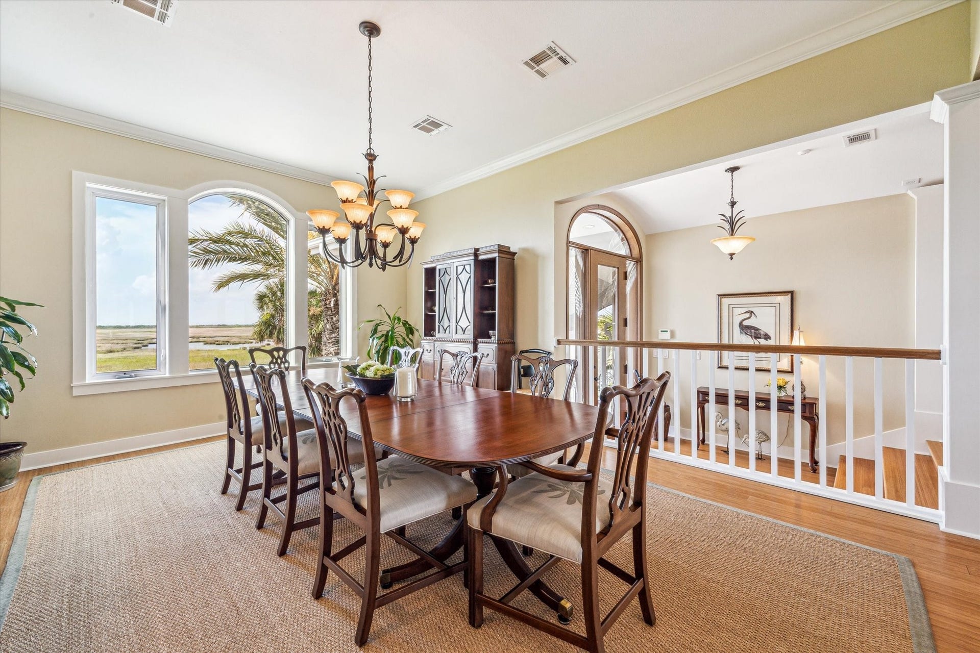1 Shell Key, Hitchcock, TX 77563 This stunning dining room offers sweeping views of the surrounding wetlands through a large picture window framed by elegant trim. A classic chandelier adds warmth and sophistication