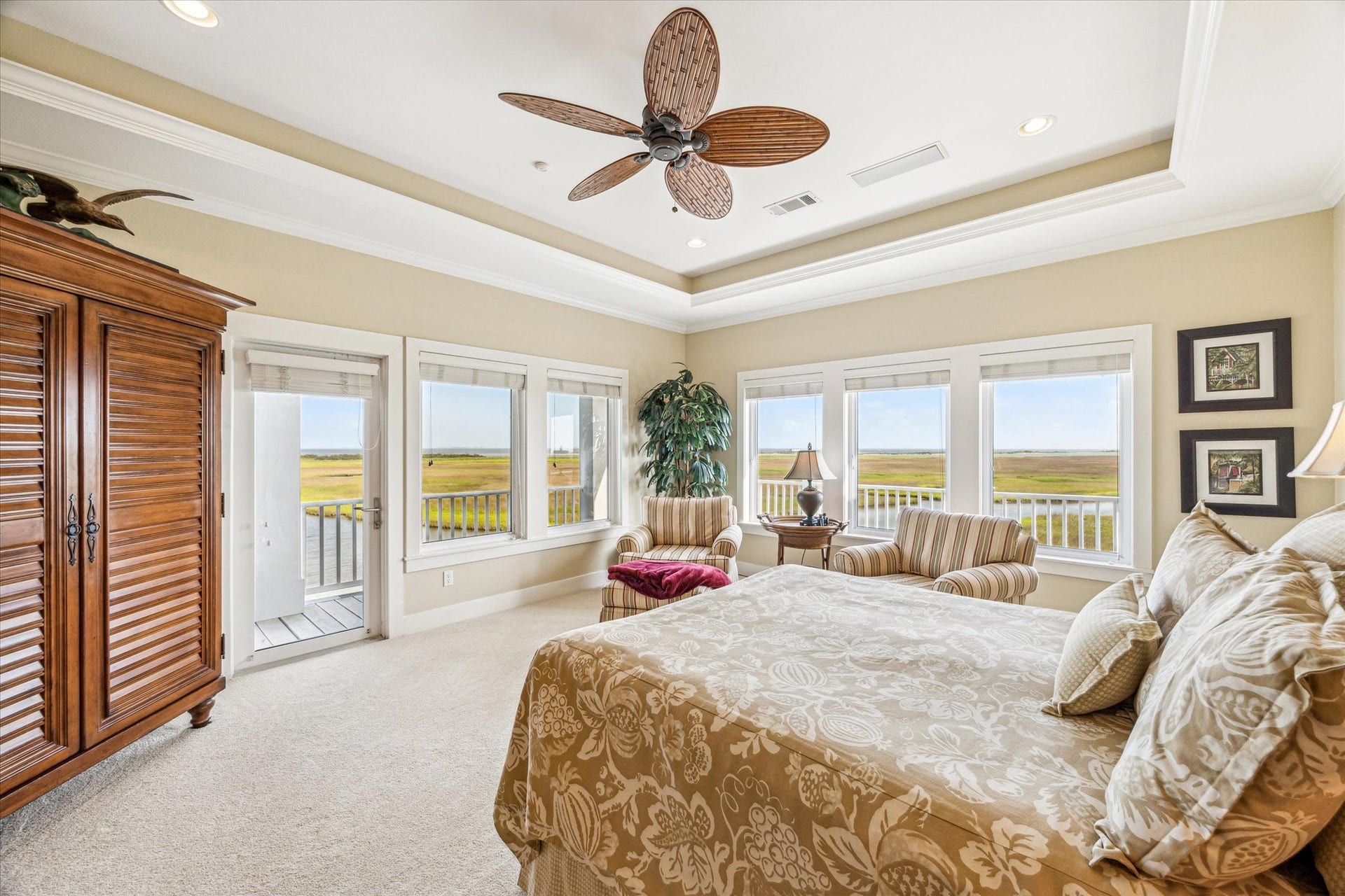 1 Shell Key, Hitchcock, TX 77563 Expansive windows flood in natural light and showcasing unobstructed views of the bay and wetlands while direct access to the balcony enhances the indoor-outdoor living experience
