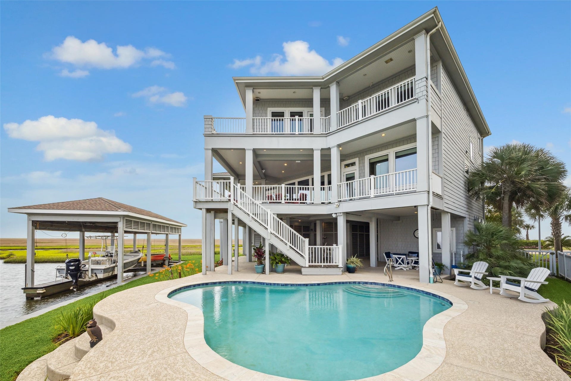 1 Shell Key, Hitchcock, TX 77563 Outdoor living is elevated with premium IPE wood decking on both levelsenjoy a spacious covered deck off the kitchen and family room, a separate sunset-view deck, and upper-level covered and open decks off both the primary and secondary primary suites
