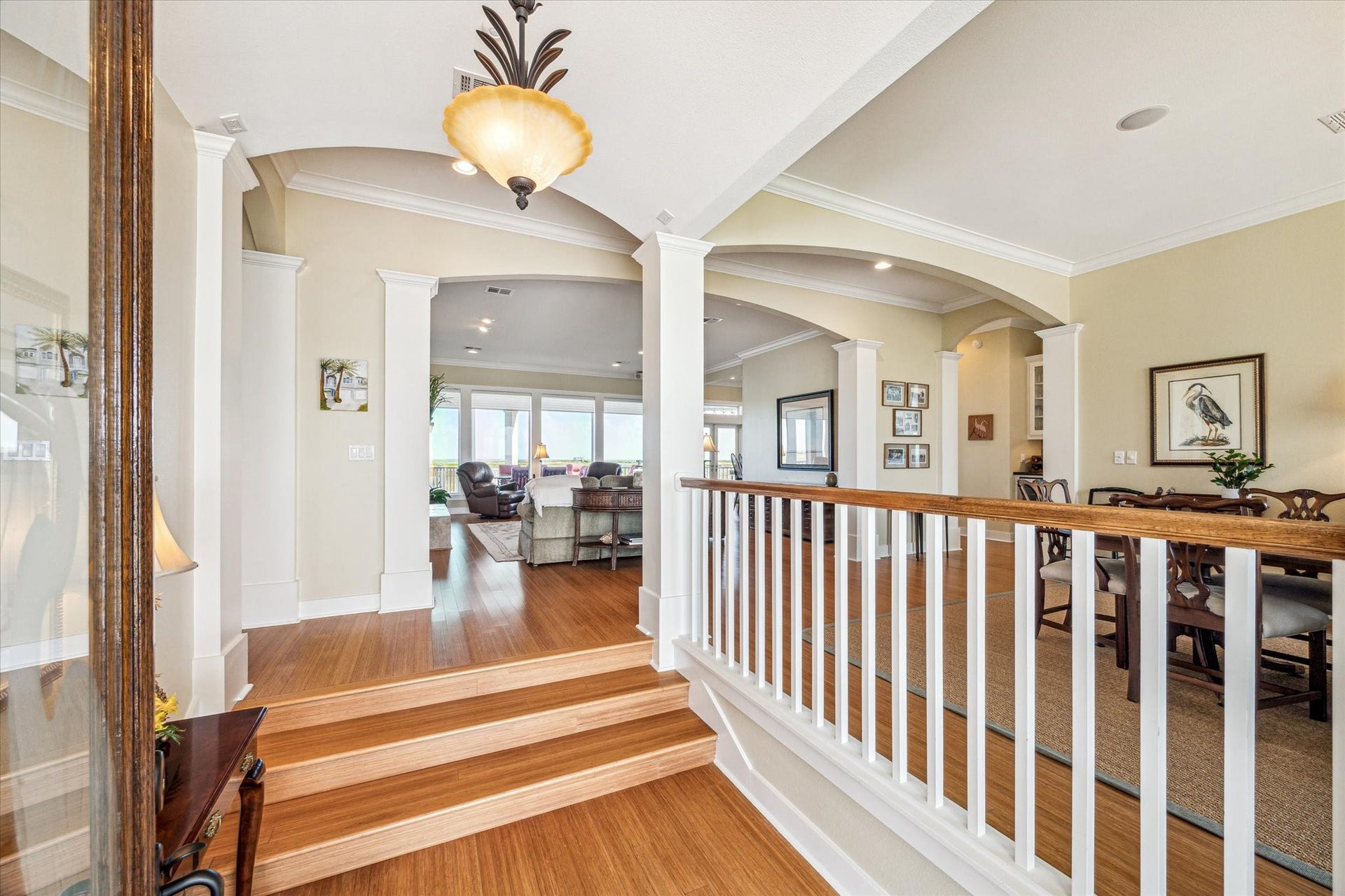 1 Shell Key, Hitchcock, TX 77563 Upon entry, you're welcomed by rich bamboo flooring and staircase that leads into an open-concept layout. Elegant wood-columned archways define the space, creating a seamless flow from the foyer to the living and dining areas and beyond