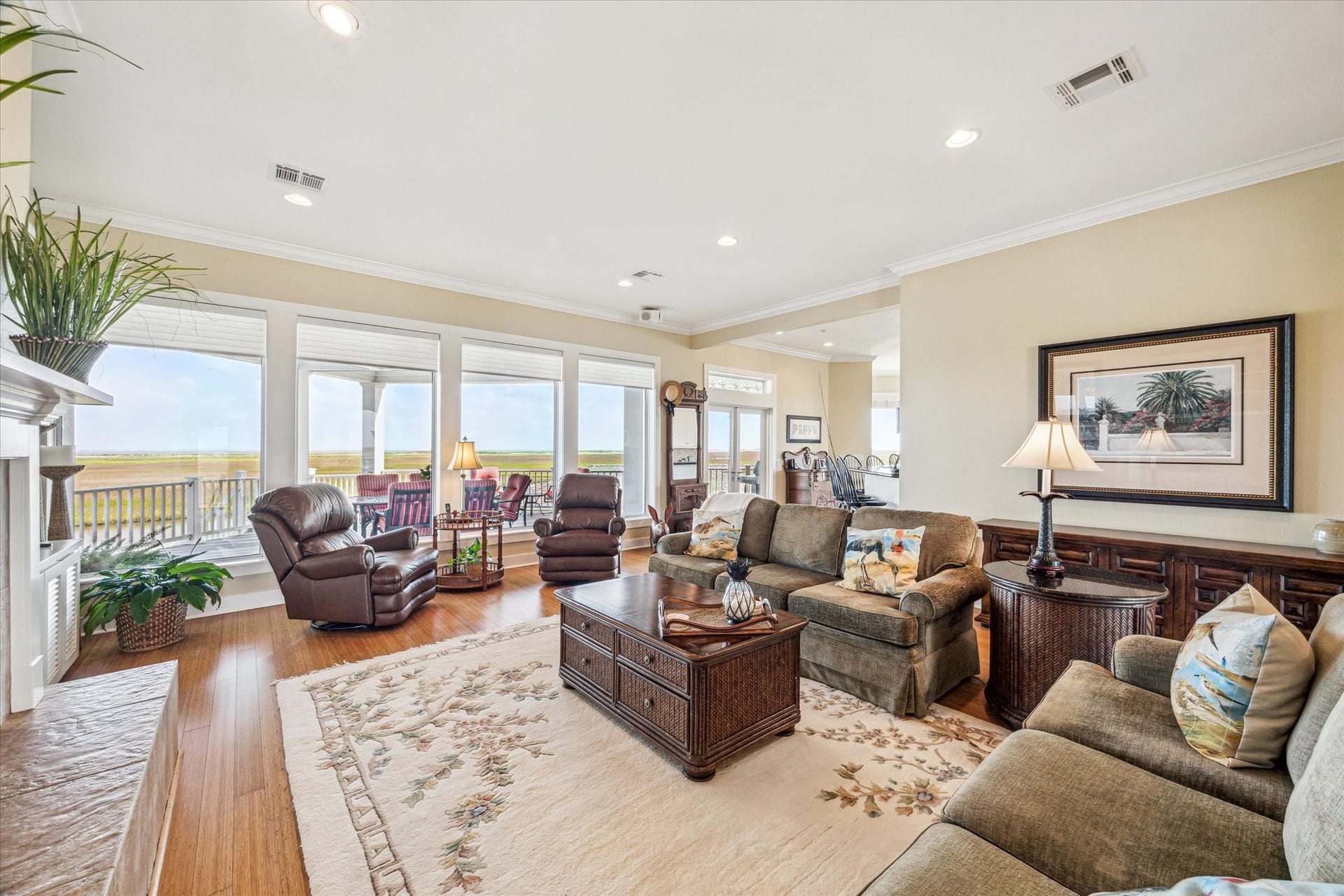 1 Shell Key, Hitchcock, TX 77563 An elegant living space showcasing timeless design and modern comfort, featuring bamboo floors and tile throughout the main level for both style and durability. A wall of windows offers endless views from the comfort of your home, or step out onto the covered deck to take it all in