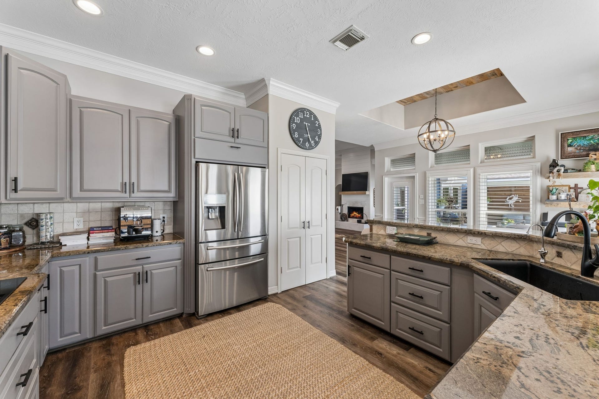 1623 Dick Bay Drive, San Leon, TX 77539 Thoughtfully designed kitchen offers abundant counter space, a large peninsula, and ample storage for effortless meal preparation. Windows overlooking the outdoor spaces bring natural light into the heart of the home.