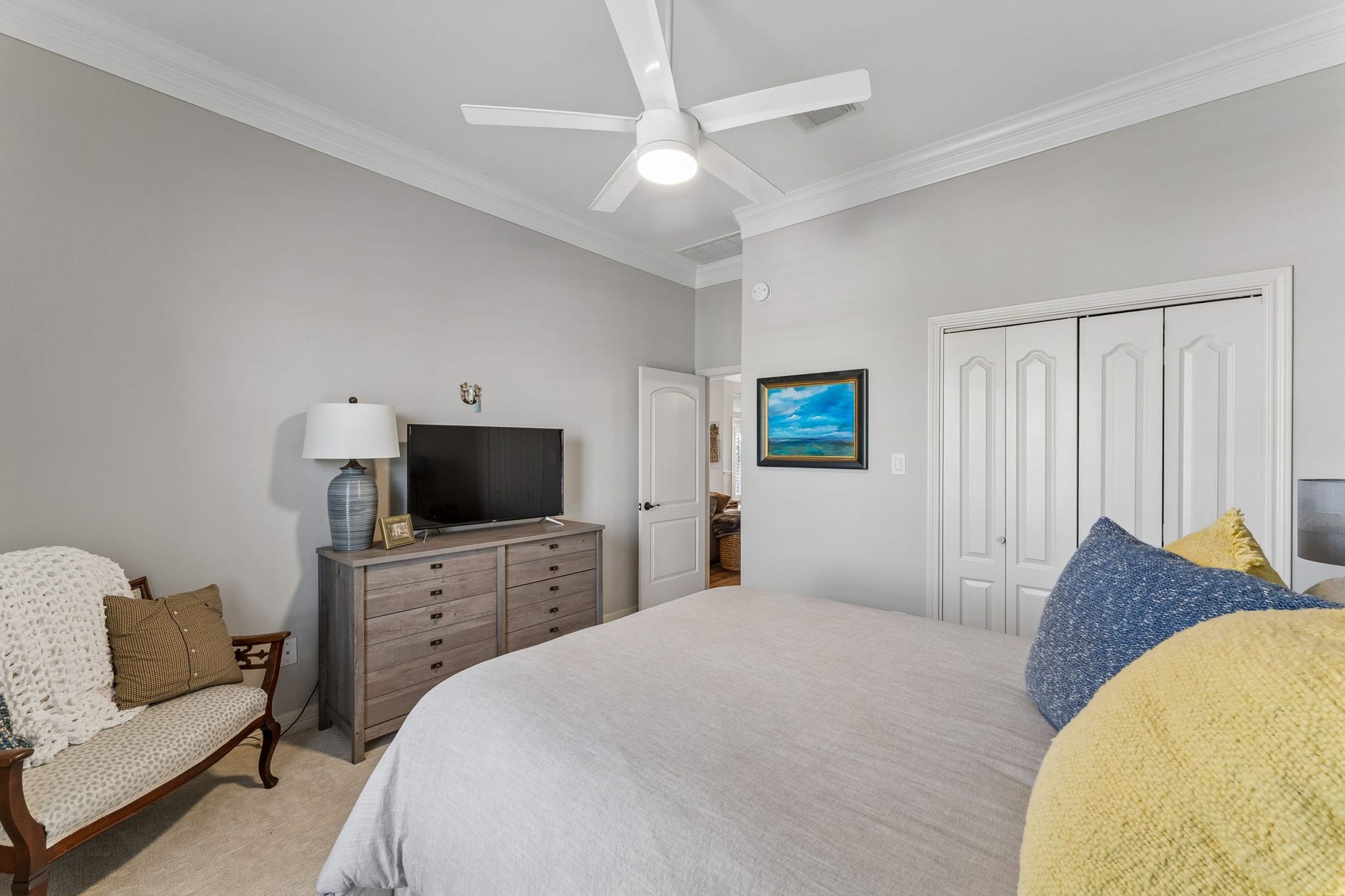 1623 Dick Bay Drive, San Leon, TX 77539 Generously sized bedroom features ample closet space and a clean, neutral palette. Crown molding and a modern ceiling fan add a polished finishing touch.