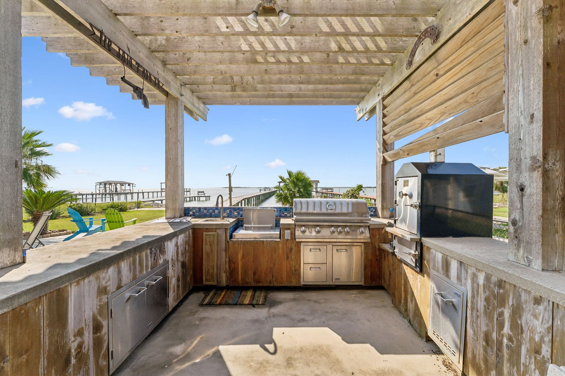 1623 Dick Bay Drive, San Leon, TX 77539 Outdoor kitchen features built in grilling and cooking stations with generous prep space for hosting by the water. Open views toward Galveston Bay make every cookout feel like a coastal getaway.