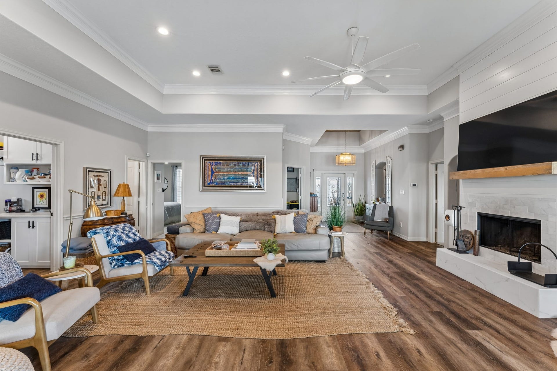 1623 Dick Bay Drive, San Leon, TX 77539 Expansive great room with soaring ceilings, warm wood flooring, and an inviting wood burning fireplace. The open layout creates an effortless flow for everyday living and entertaining.