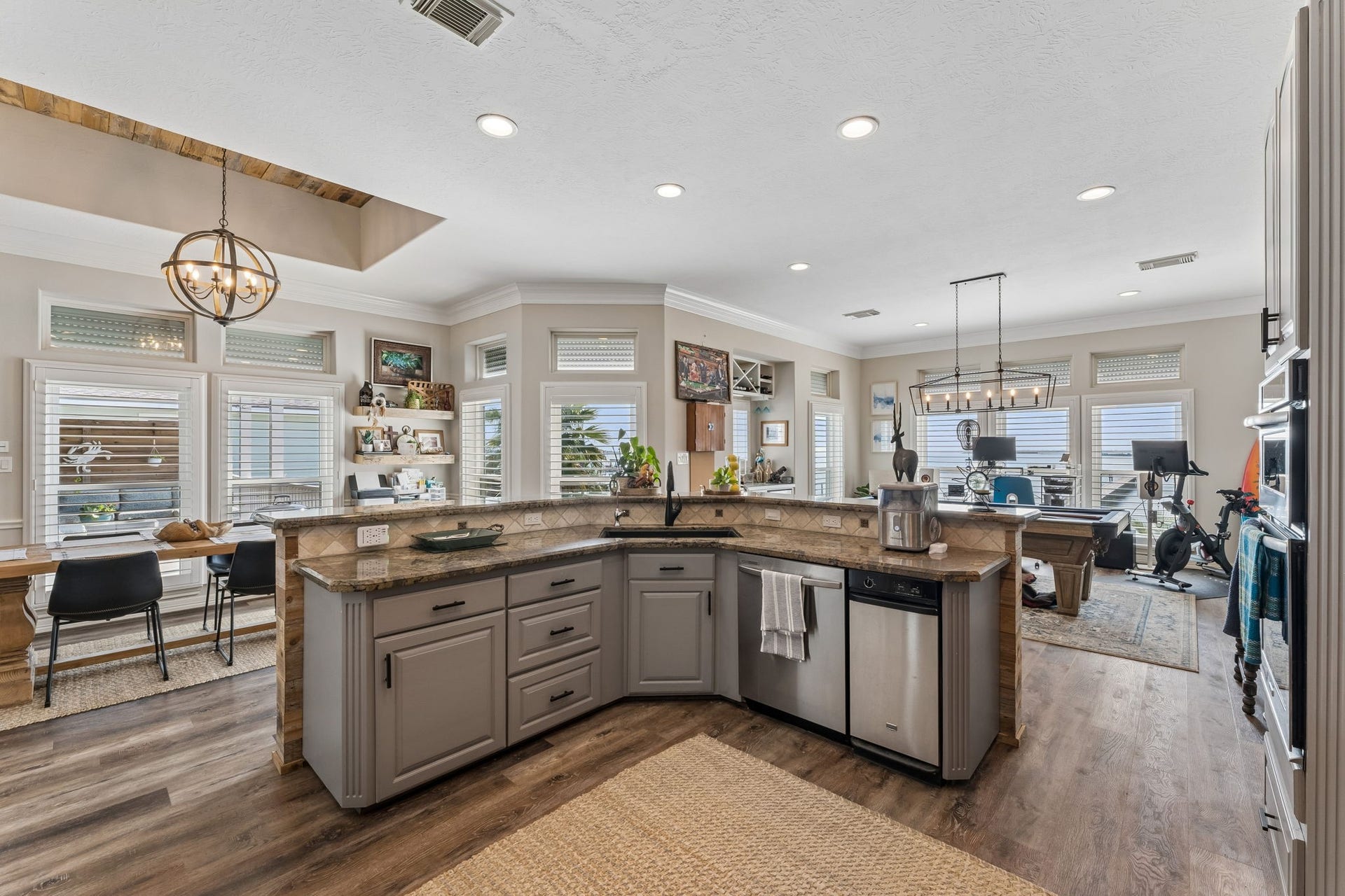 1623 Dick Bay Drive, San Leon, TX 77539 Open kitchen design creates an easy connection between cooking, dining, and recreation spaces. Expansive granite surfaces provide plenty of room for prep and serving.