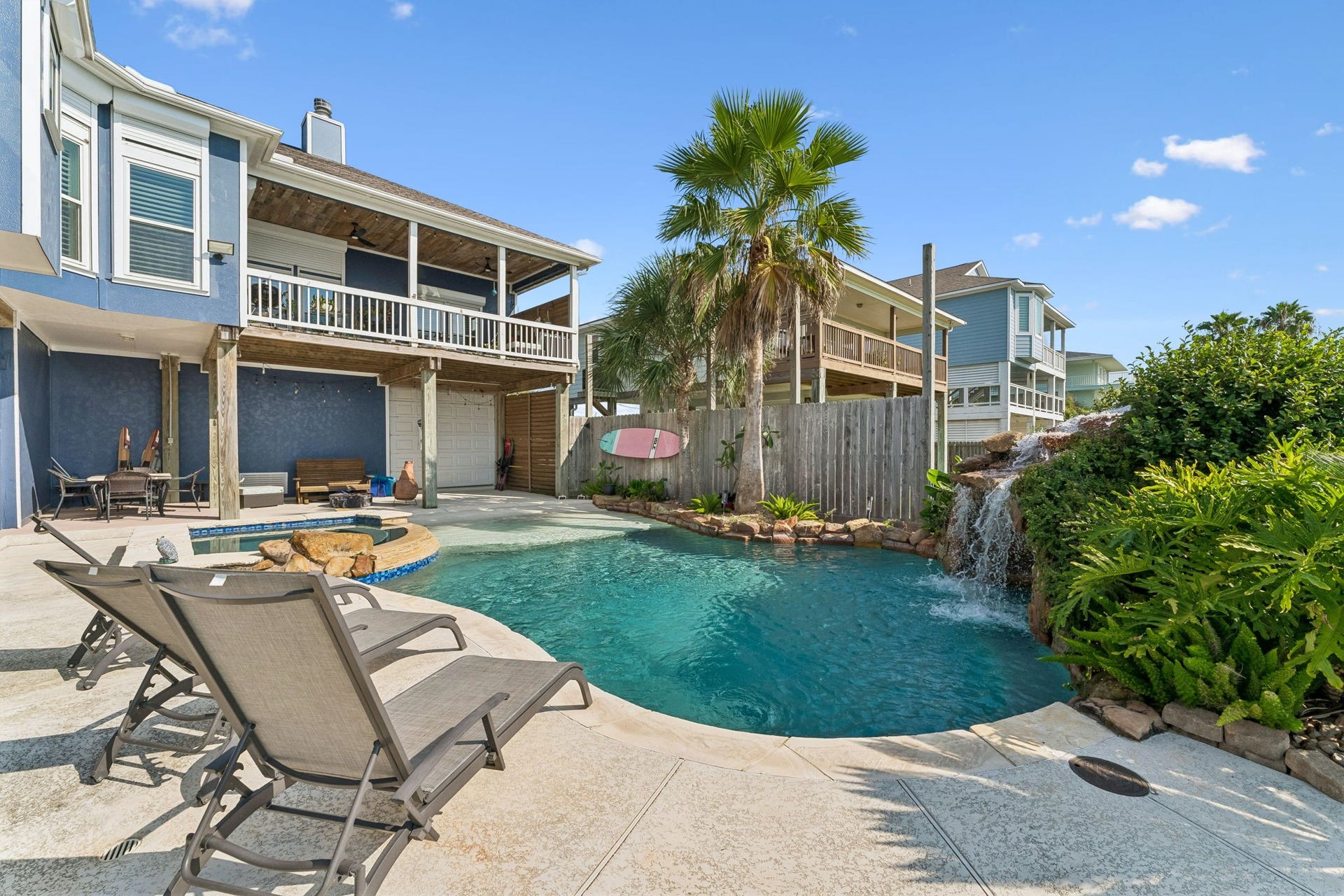 1623 Dick Bay Drive, San Leon, TX 77539 Private backyard oasis pairs a sparkling pool with lush tropical landscaping and a cascading rock waterfall. Expansive decking offers plenty of room to lounge, entertain, and enjoy the coastal sunshine.