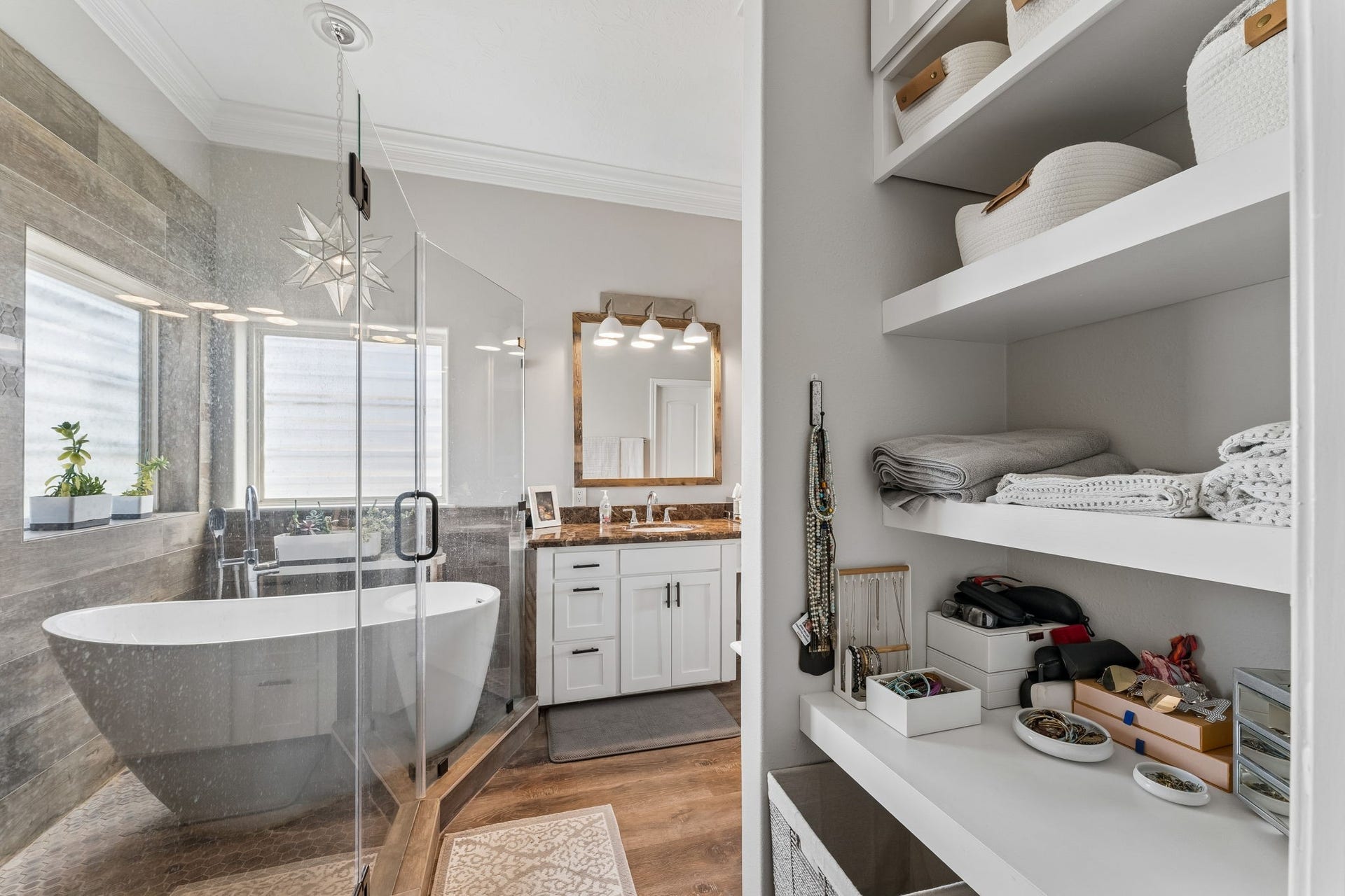 1623 Dick Bay Drive, San Leon, TX 77539 Thoughtfully designed primary ensuite includes built in open shelving for convenient storage and organization. The glass enclosed wet room pairs a freestanding soaking tub with a spacious shower for a true spa experience.