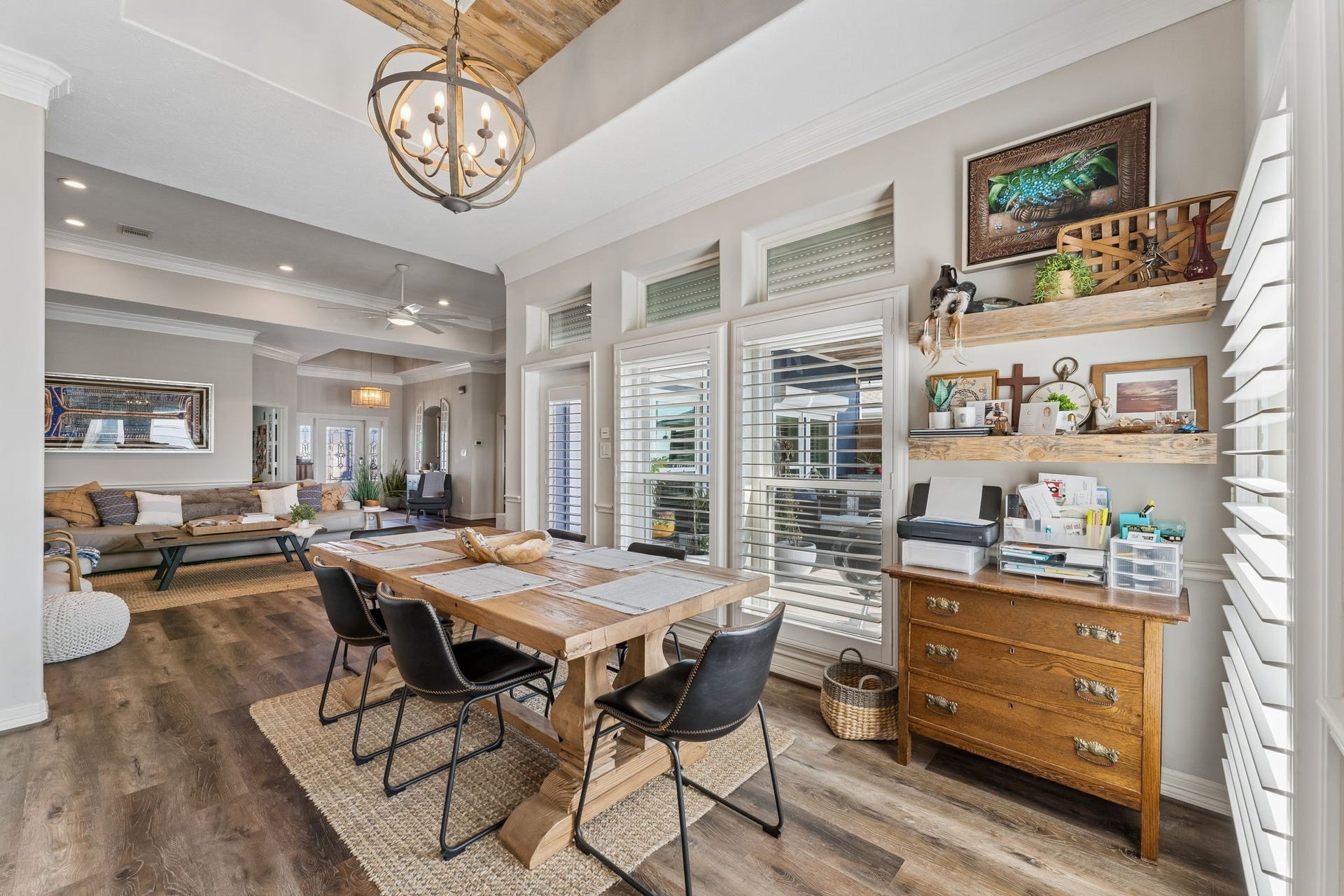 1623 Dick Bay Drive, San Leon, TX 77539 Bright dining area offers an inviting place to gather with seamless flow into the great room. Plantation shutters, floating wood shelves, and statement lighting add warmth and character.