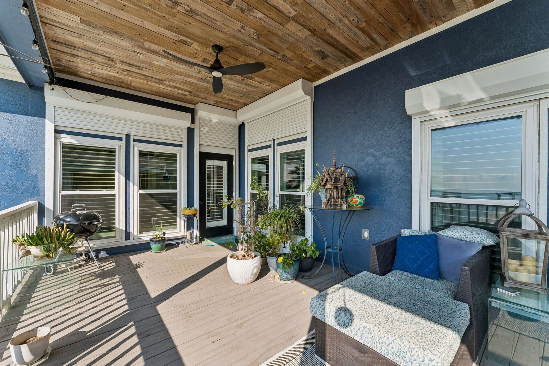 1623 Dick Bay Drive, San Leon, TX 77539 Covered balcony creates a relaxing outdoor lounge with shade, ceiling fan, and comfortable seating. Enjoy refreshing bay breezes and water views just beyond the railing.