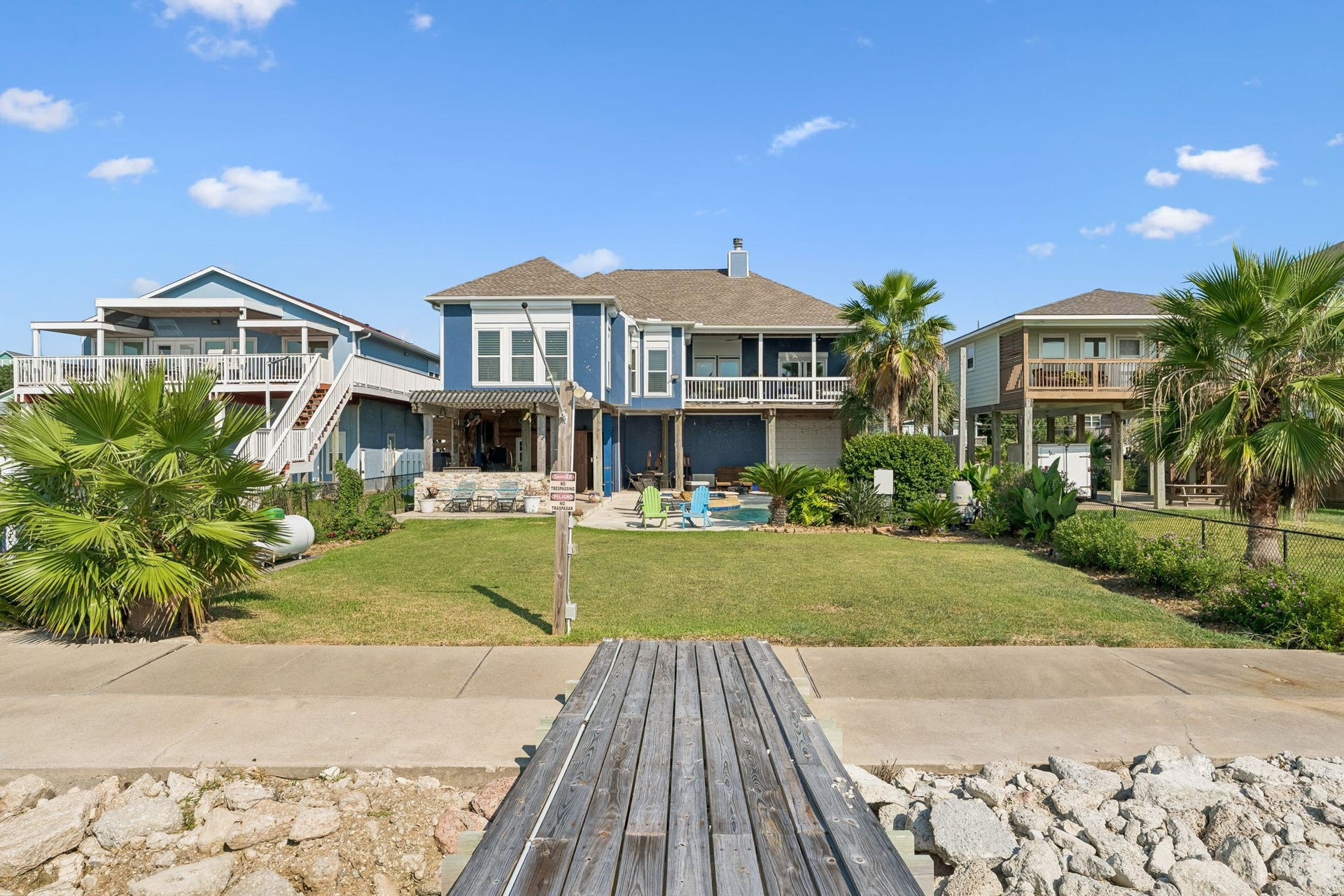 1623 Dick Bay Drive, San Leon, TX 77539 Private pier leads directly from the backyard to the waters of Galveston Bay. A generous lawn and tropical landscaping create a beautiful transition from home to waterfront.