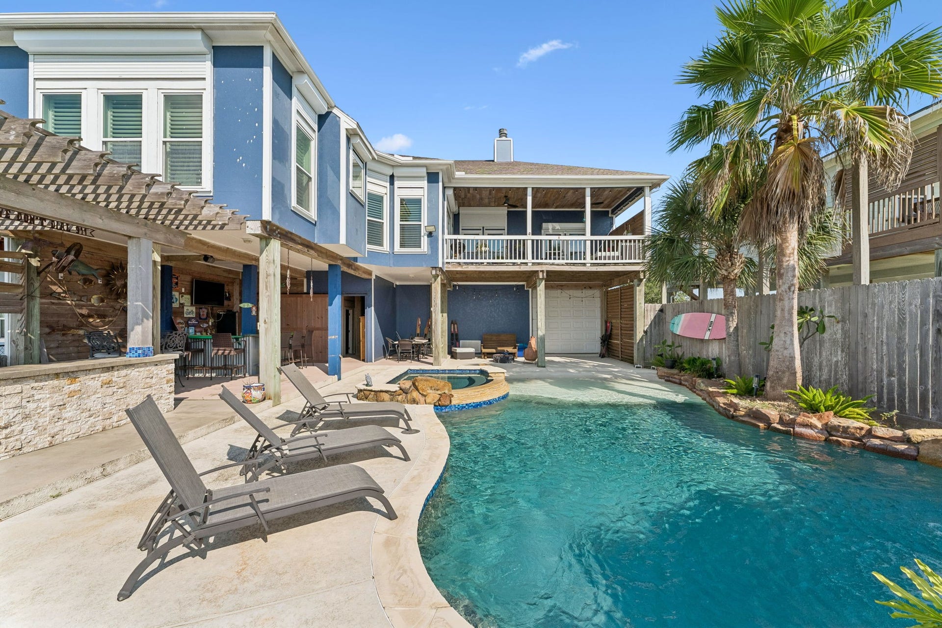 1623 Dick Bay Drive, San Leon, TX 77539 Expansive poolside setting showcases the homes covered outdoor living areas and upper balcony overlooking the backyard. Multiple gathering spaces create an effortless setup for enjoying the Galveston Bay lifestyle.
