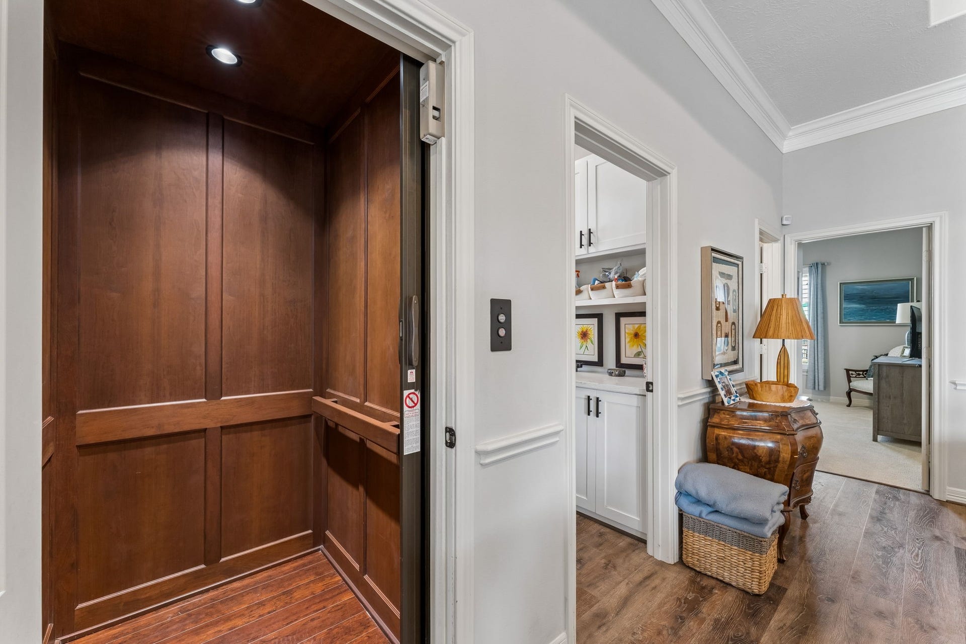 1623 Dick Bay Drive, San Leon, TX 77539 Private residential elevator provides convenient access between levels. Rich wood paneling adds a refined touch to this practical luxury feature.