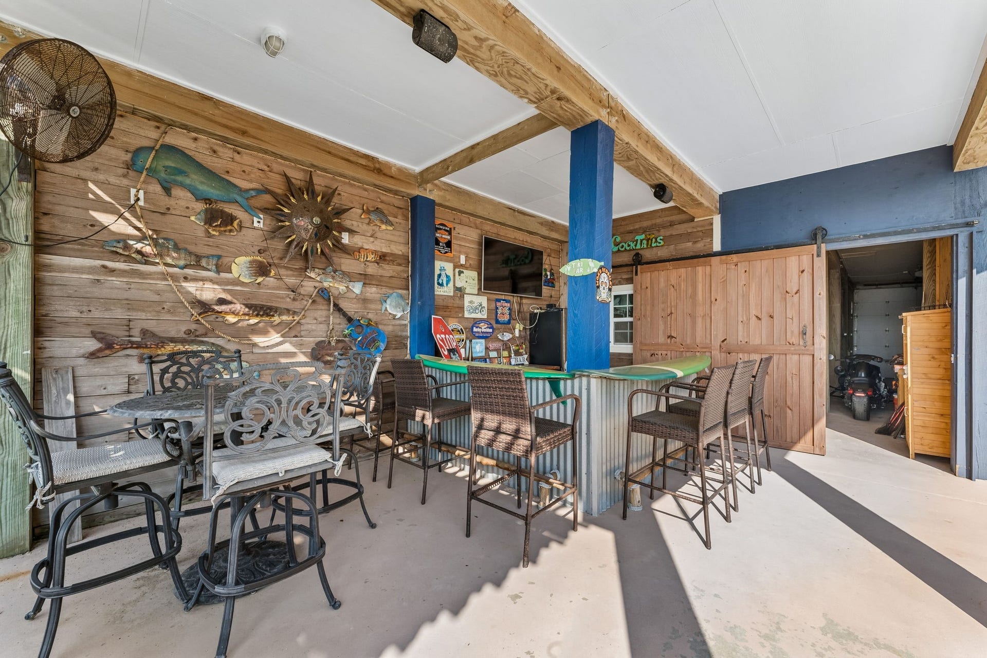 1623 Dick Bay Drive, San Leon, TX 77539 Covered entertainment area offers bar seating, a dining space, and plenty of room to gather with friends and family. Coastal inspired details give this outdoor space a relaxed waterfront personality.