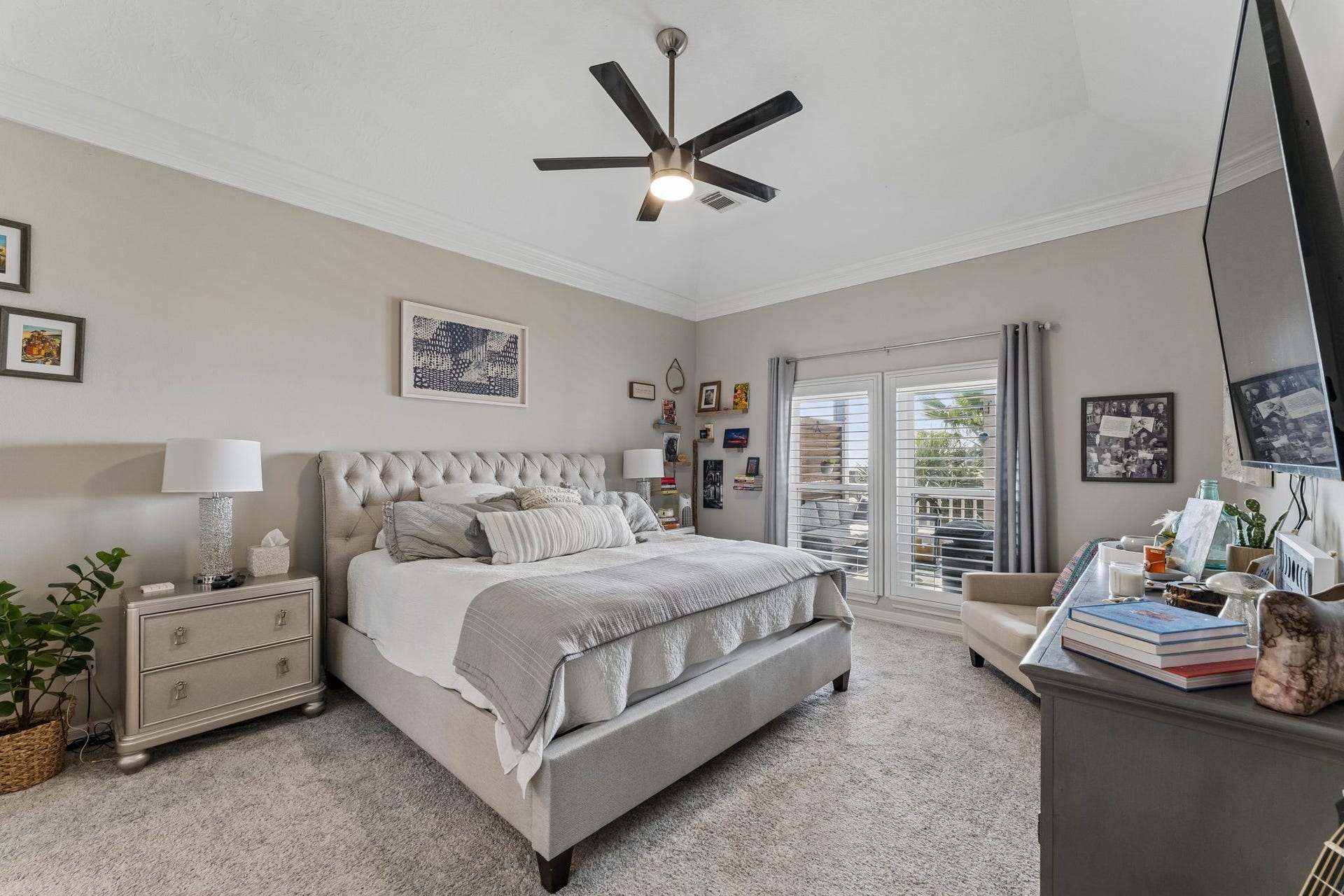 1623 Dick Bay Drive, San Leon, TX 77539 Spacious primary suite offers a serene setting with high ceilings and plush finishes. French doors open to a private balcony, extending the living space outdoors.