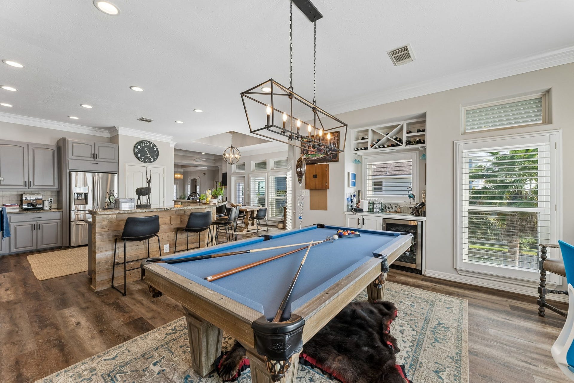 1623 Dick Bay Drive, San Leon, TX 77539 Game room connects effortlessly to the kitchen and features a built in beverage station with wine storage. A full size pool table makes this space ready for entertaining.