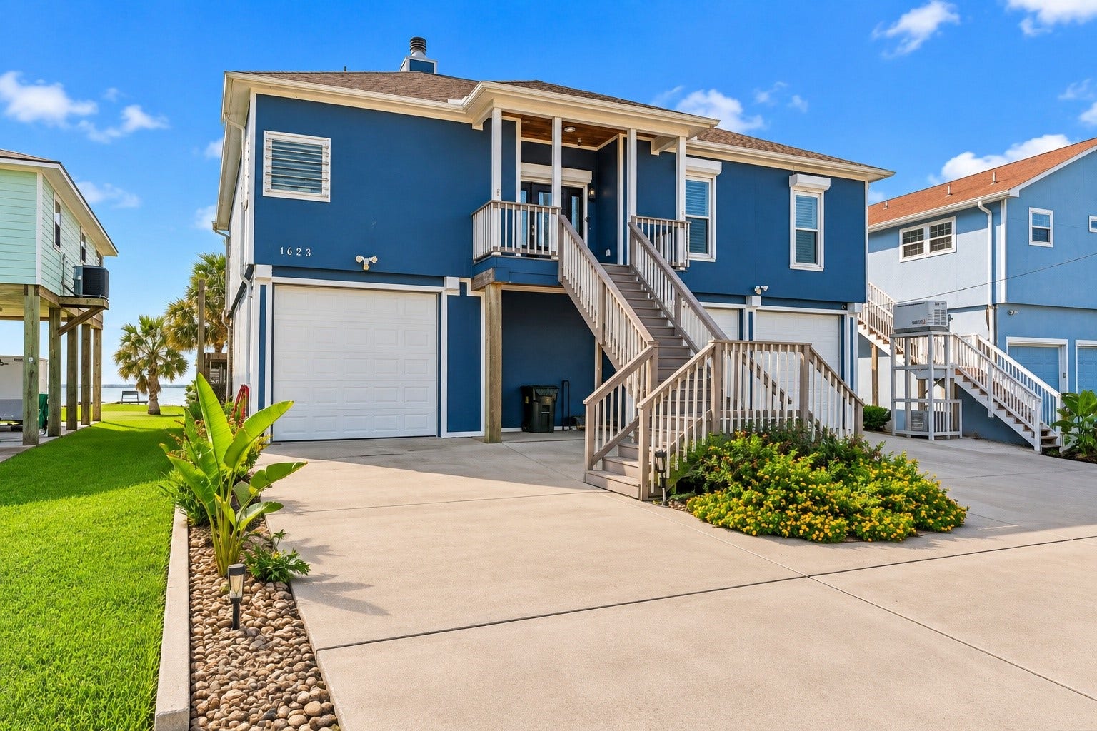1623 Dick Bay Drive, San Leon, TX 77539 Wide driveway provides generous parking and easy access to the garage beneath the elevated home. Manicured landscaping and coastal architecture create a welcoming curb appeal.
