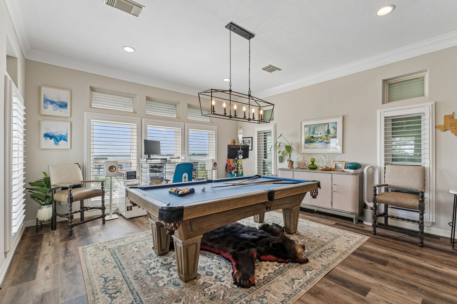 1623 Dick Bay Drive, San Leon, TX 77539 Versatile game room offers plenty of space for a pool table, lounge seating, and entertainment. Walls of windows keep the space bright while capturing views of the waterfront surroundings.