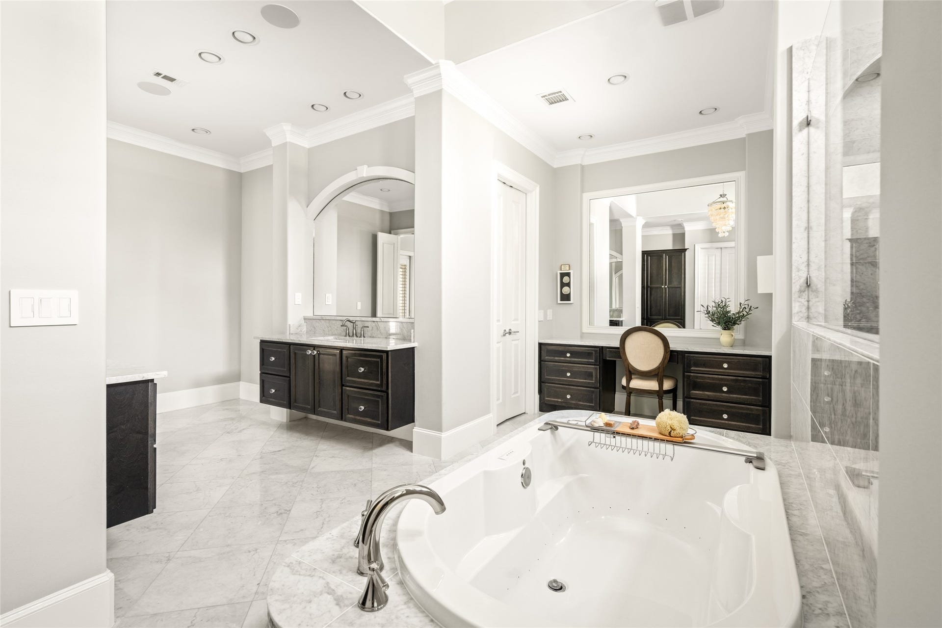 There is a dedicated vanity area with double doors to the 2-story master closet