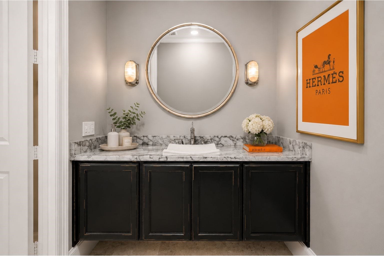 Powder guest bath on first floor near the office has floating cabinets, marble counters, and lighting under the cabinets.  Impress your guests in this lovely powder.