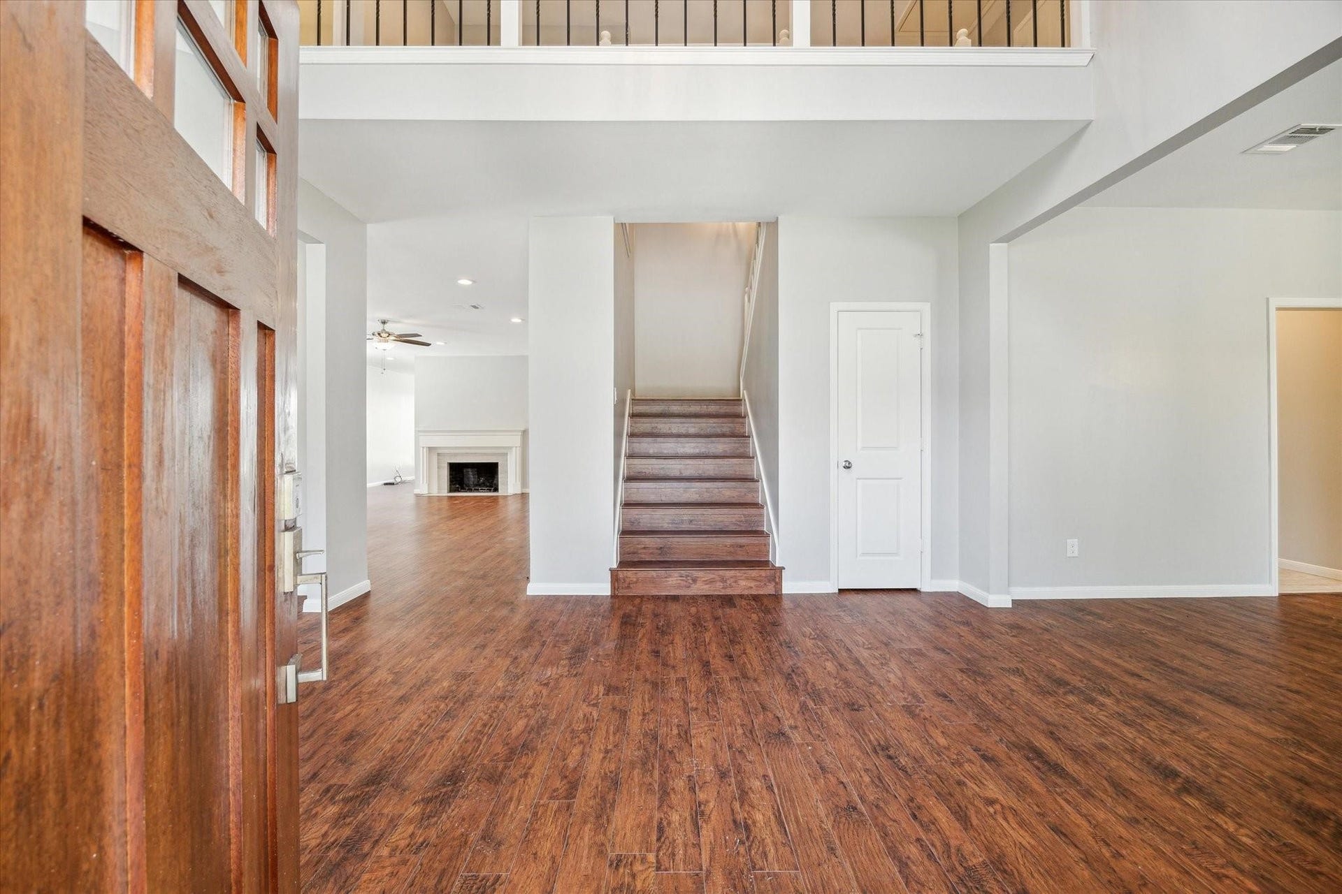 6003 Ancient Oaks Drive, Humble, TX 77346 Welcoming entry area with warm wood-look flooring, neutral walls, and an open view toward the staircase and main living spaces.