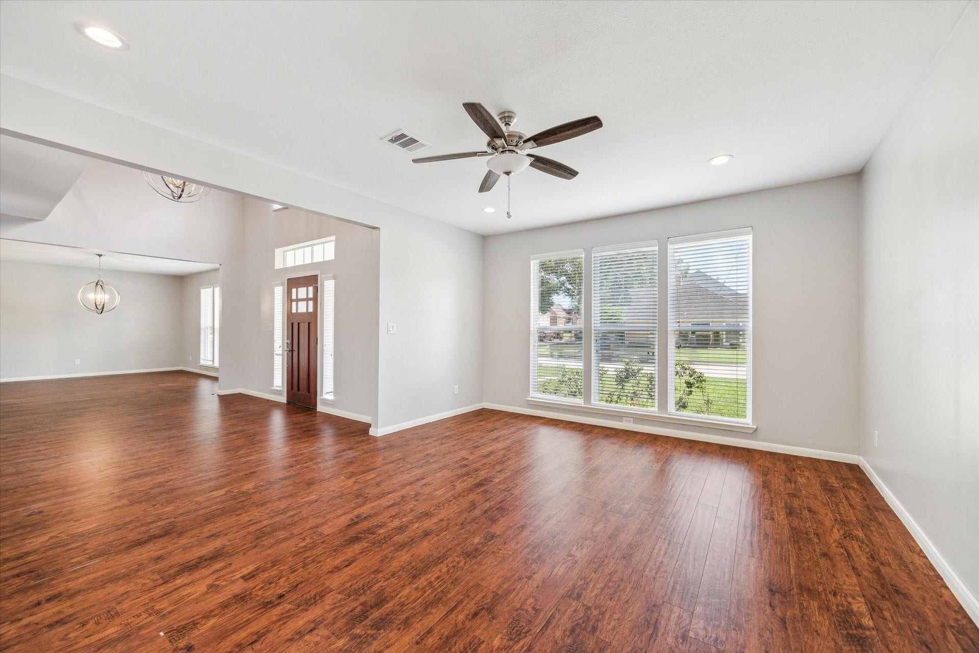 6003 Ancient Oaks Drive, Humble, TX 77346 Open living space featuring a ceiling fan, recessed lighting, large windows, and a flexible layout for relaxing or entertaining.