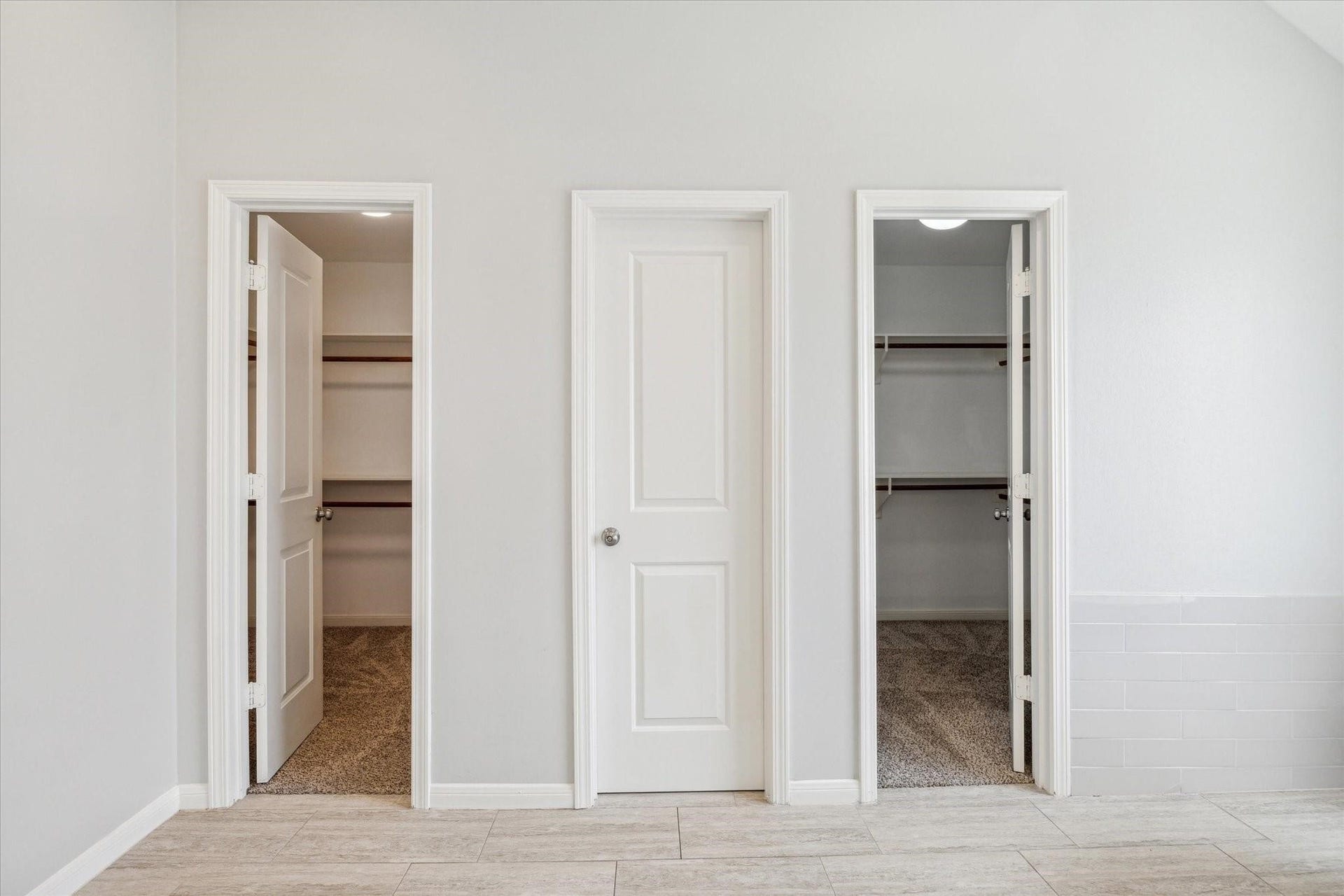 6003 Ancient Oaks Drive, Humble, TX 77346 Primary suite storage area featuring separate closets with built-in shelving for organized clothing and personal storage.