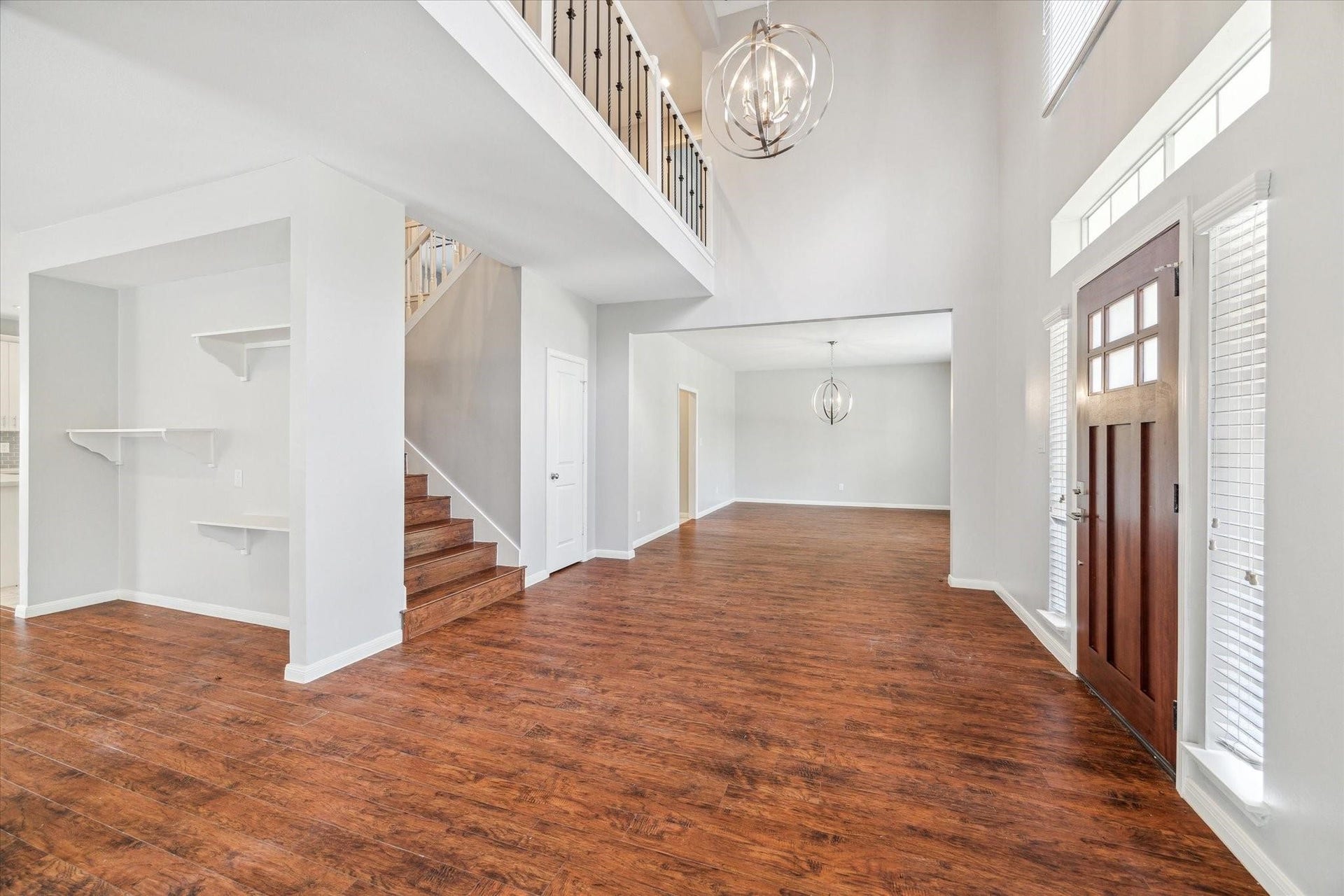 6003 Ancient Oaks Drive, Humble, TX 77346 Alternate view of the spacious main level, highlighting the open layout, abundant natural light, and access to the staircase and surrounding rooms.