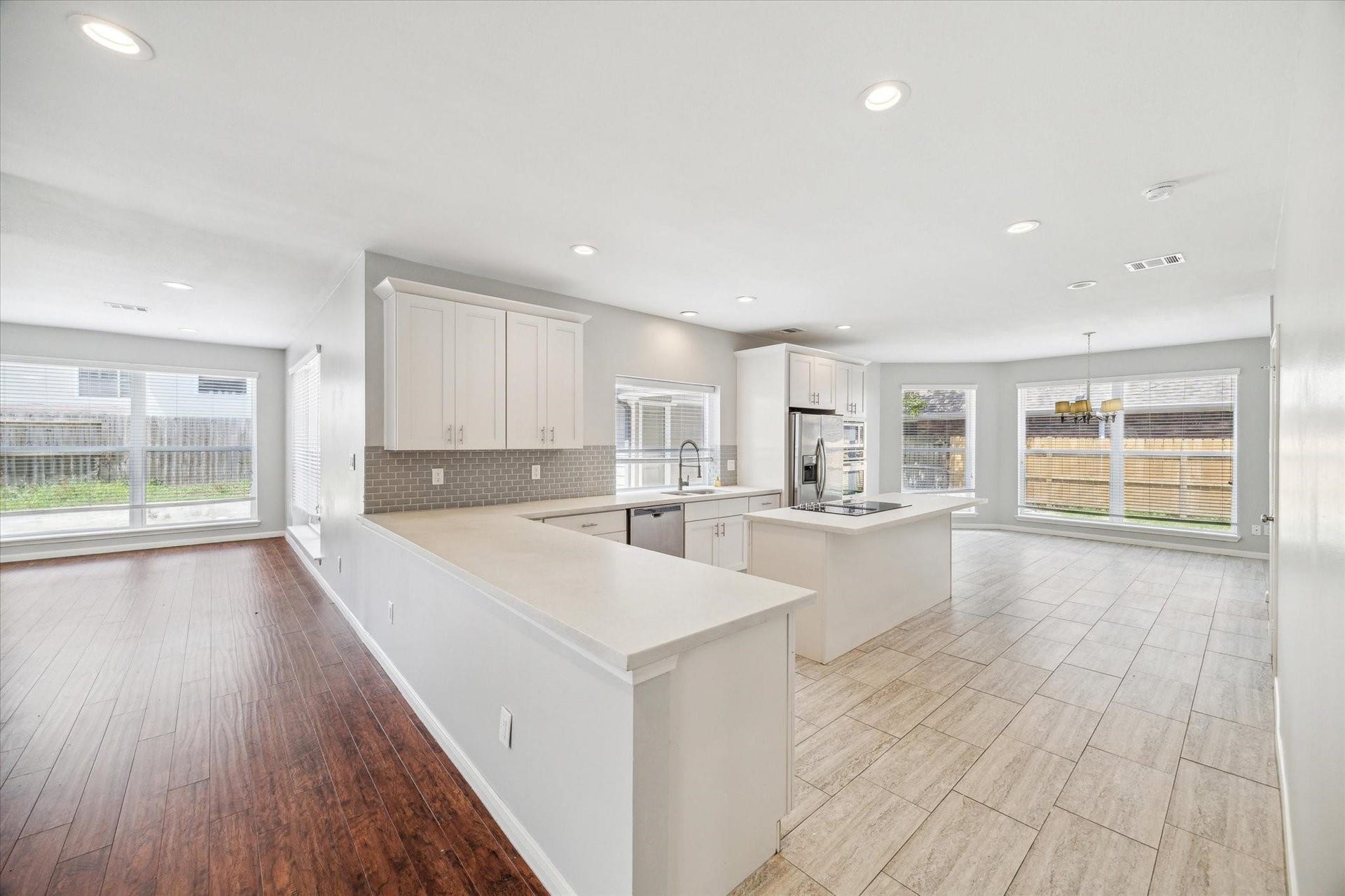 6003 Ancient Oaks Drive, Humble, TX 77346 Large kitchen island overlooking the main living area, creating a functional space for casual dining, meal preparation, and entertaining.