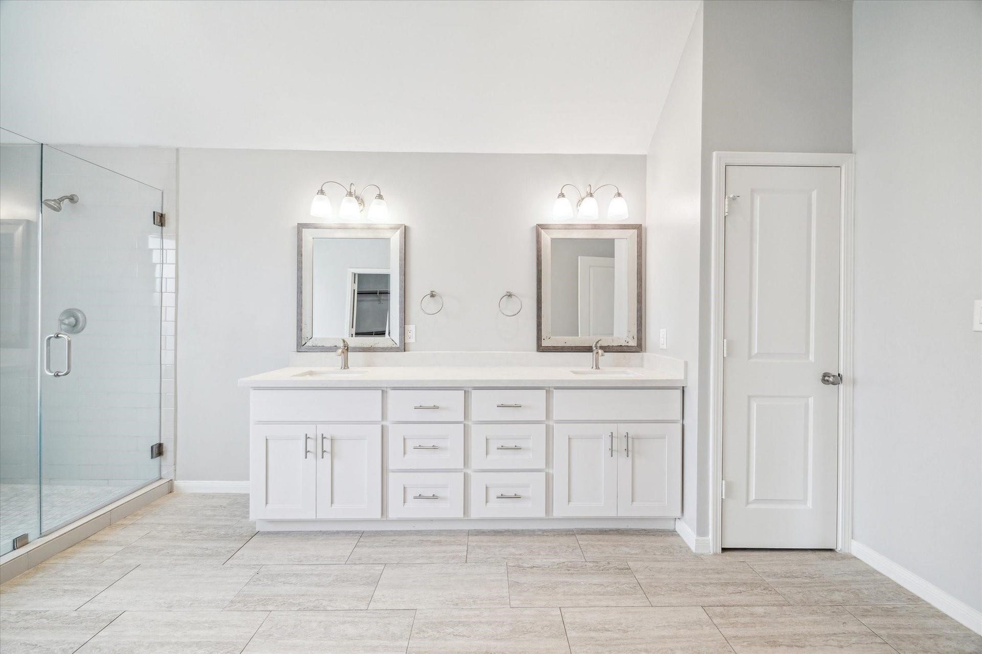 6003 Ancient Oaks Drive, Humble, TX 77346 Additional view of the remodeled primary bathroom highlighting the double vanity, updated finishes, neutral tile flooring, and glass-enclosed shower.
