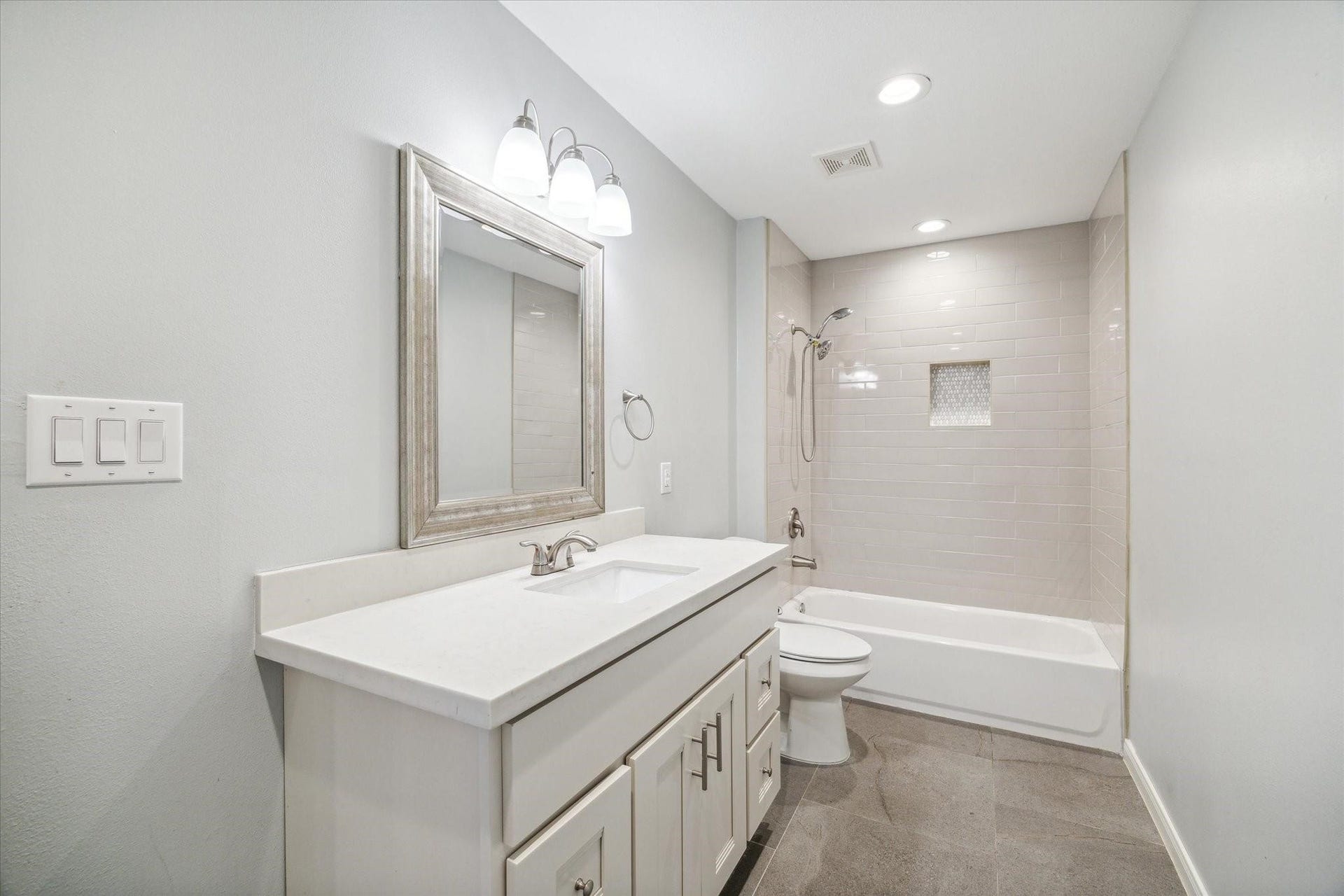 6003 Ancient Oaks Drive, Humble, TX 77346 Updated secondary bathroom with a spacious vanity, framed mirror, modern lighting, and a shower-and-tub combination.
