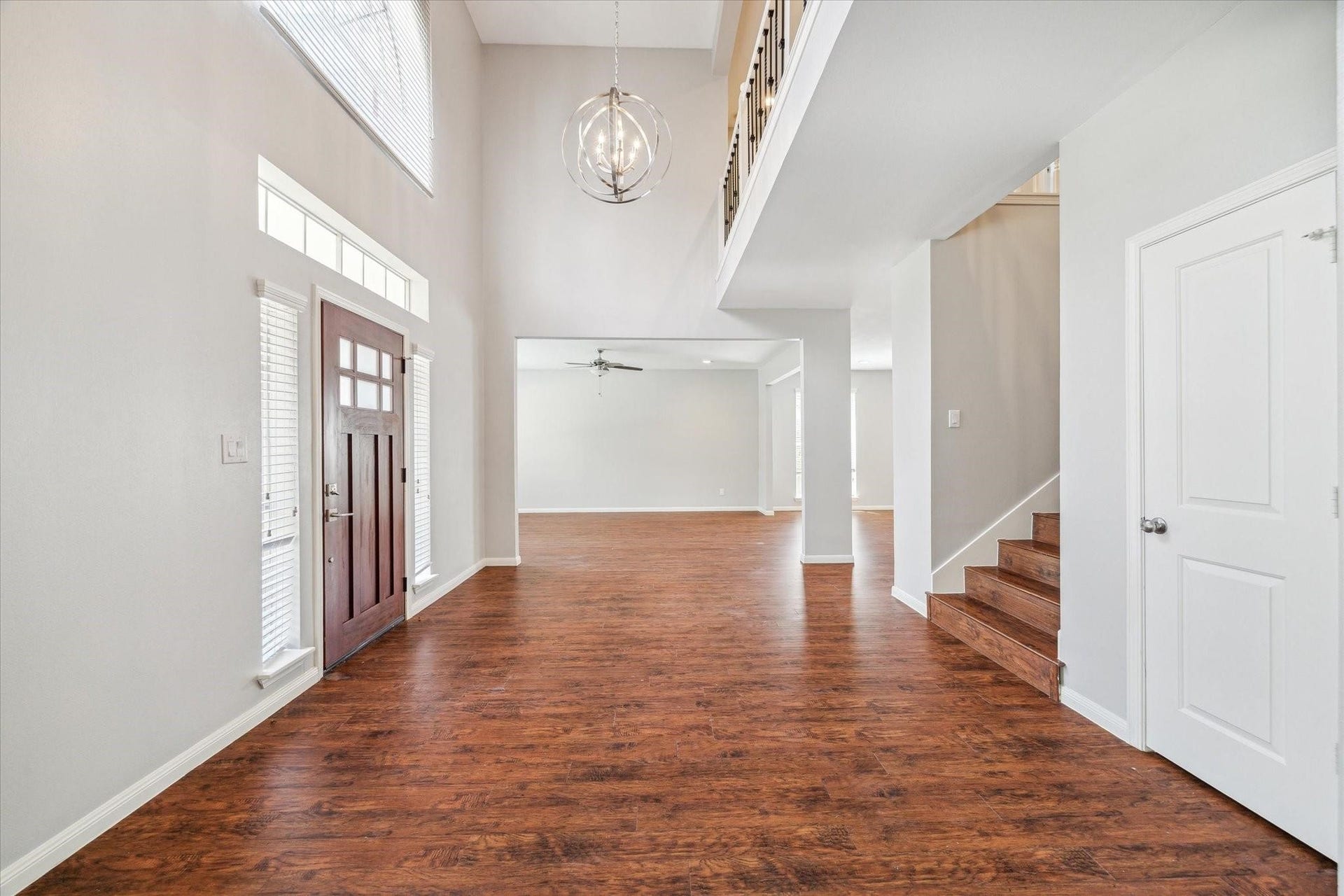 6003 Ancient Oaks Drive, Humble, TX 77346 Open-concept interior featuring wood-look flooring, freshly painted walls, high ceilings, and a layout that flows easily between the living and dining areas.