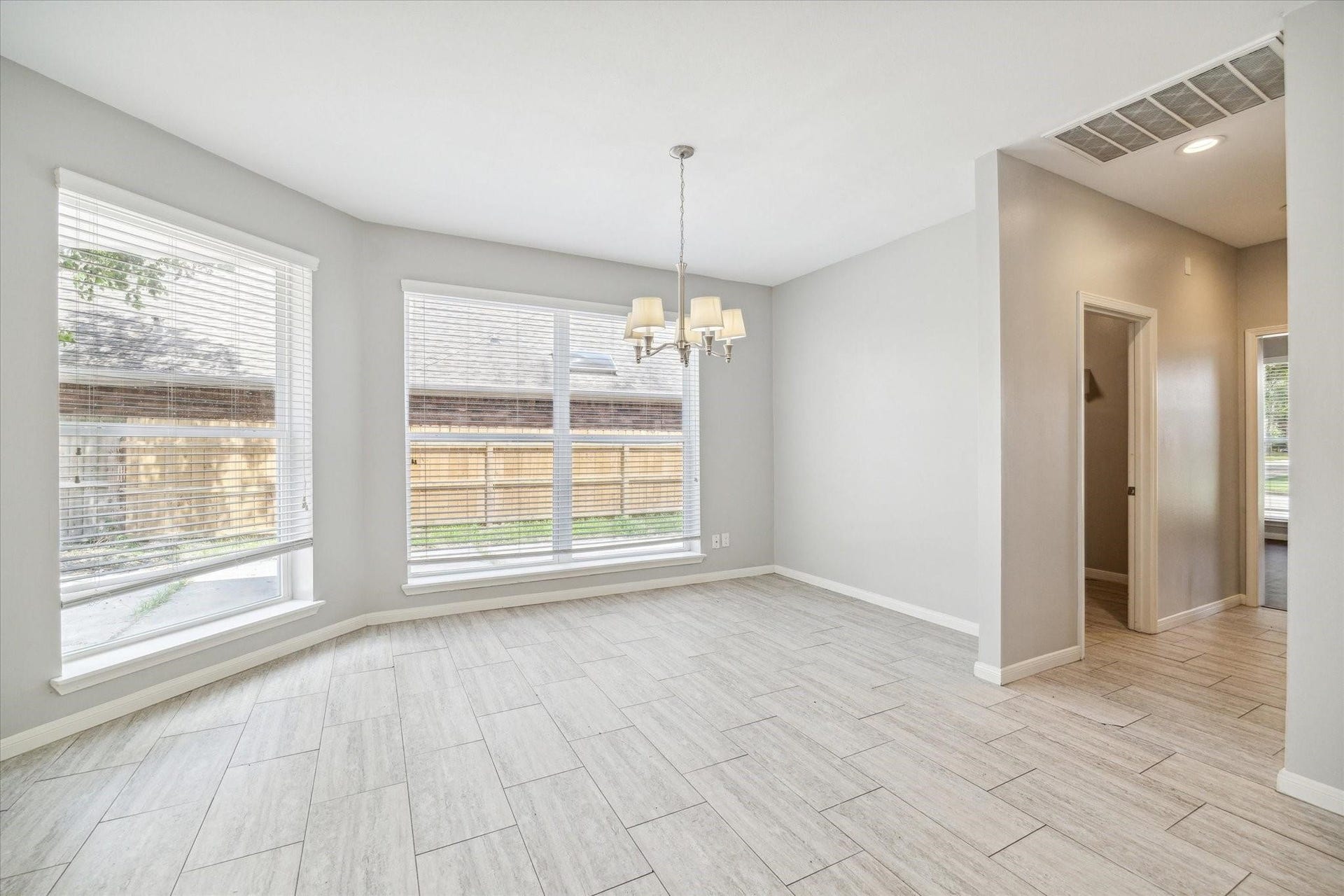 6003 Ancient Oaks Drive, Humble, TX 77346 Bright dining or breakfast area with tile flooring, a decorative light fixture, and multiple windows providing plenty of natural light.