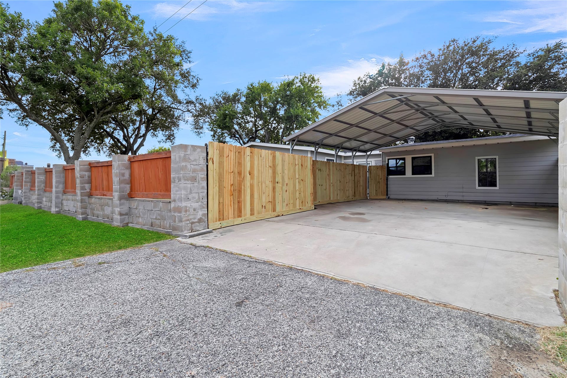 604 19th Avenue N, Texas City, TX 77590 Generous covered parking area with newly installed wood privacy fencing and convenient side access.