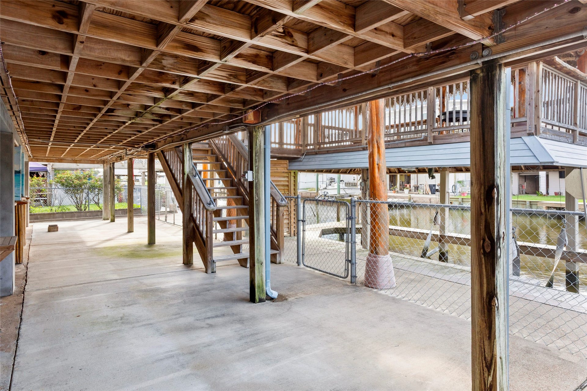31 Lakeside Drive, Hitchcock, TX 77563 Enjoy serene waterfront views from your spacious, covered ground-level deck.