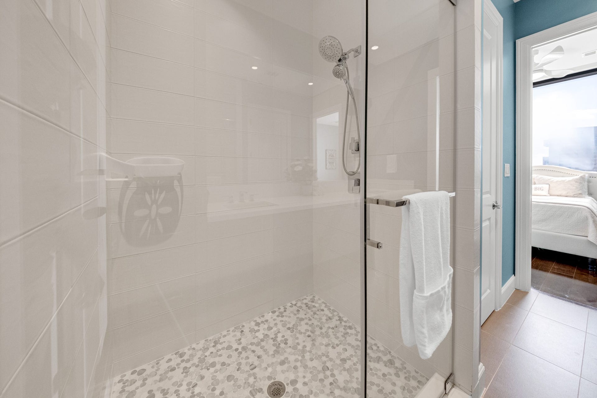 1211 Caroline Street, #1801, Houston, TX 77002 Contemporary bath featuring a
glass-enclosed shower with a
rainfall showerhead and pebble
patterned floor.