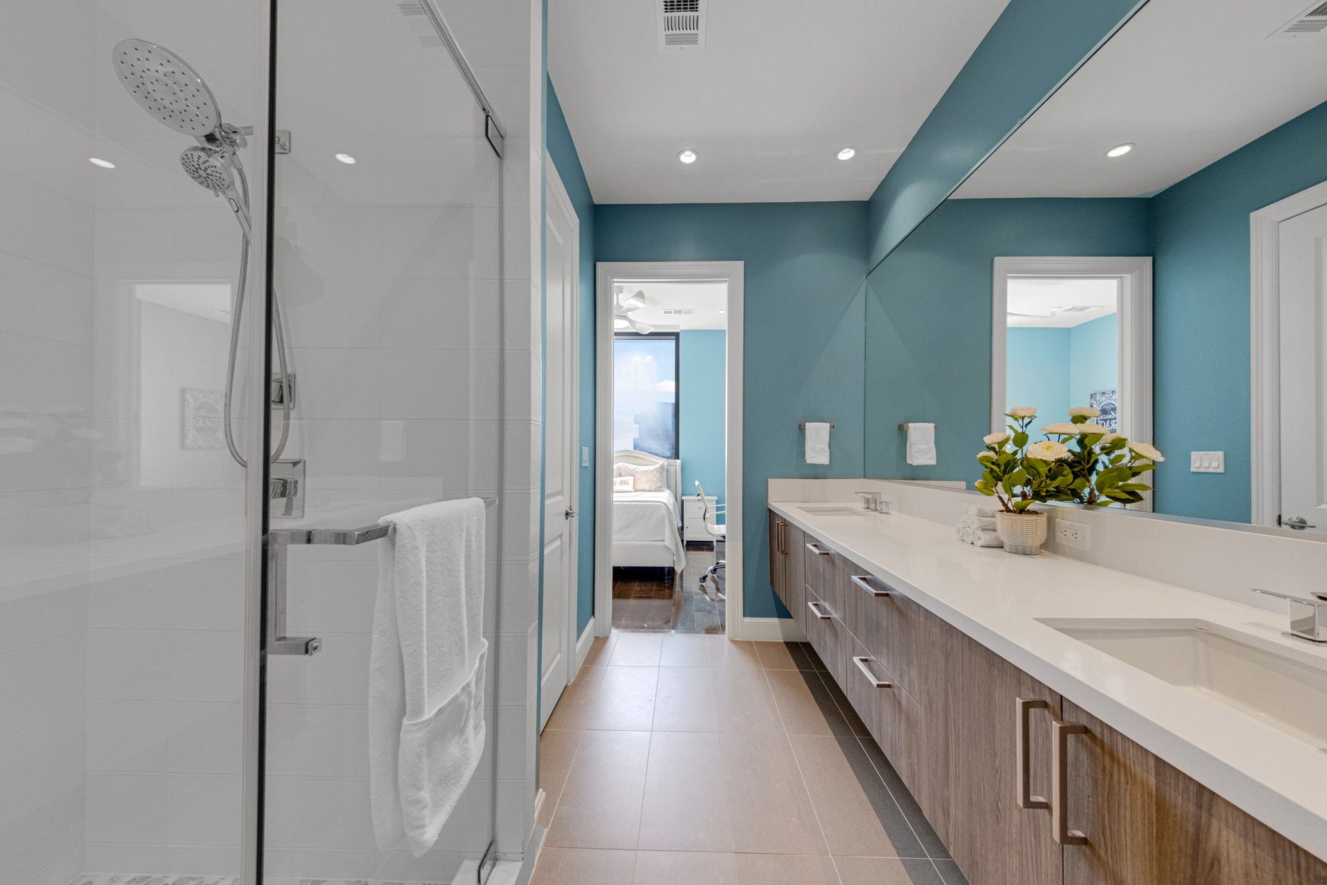 1211 Caroline Street, #1801, Houston, TX 77002 Well-appointed ensuite bath with
a spacious double vanity, sleek
wood cabinetry, and a glass
enclosed shower for a clean,
modern feel.