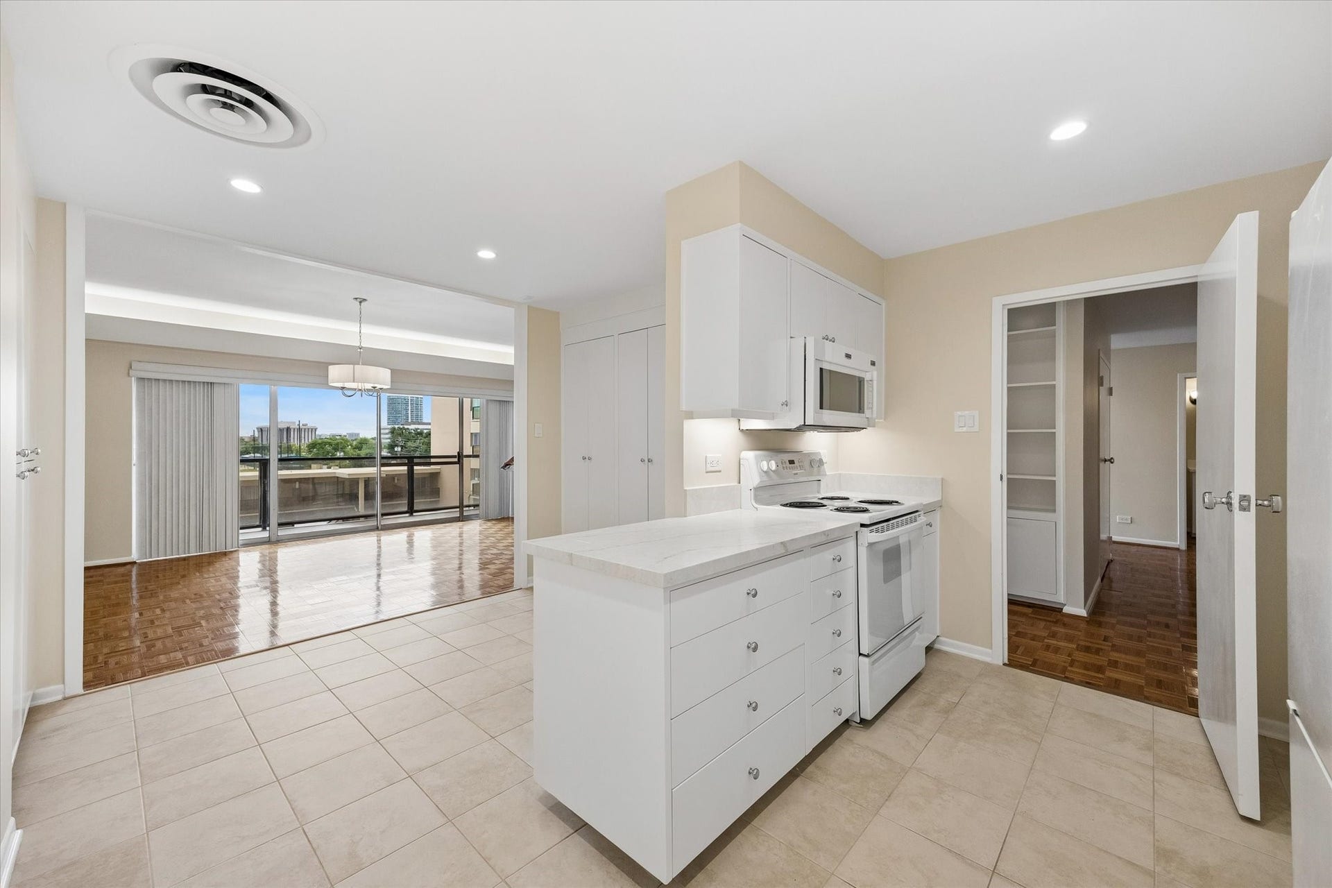 2929 Buffalo Speedway, #A303, Houston, TX 77098 Kitchen with new granite countertops and island looking towards balcony