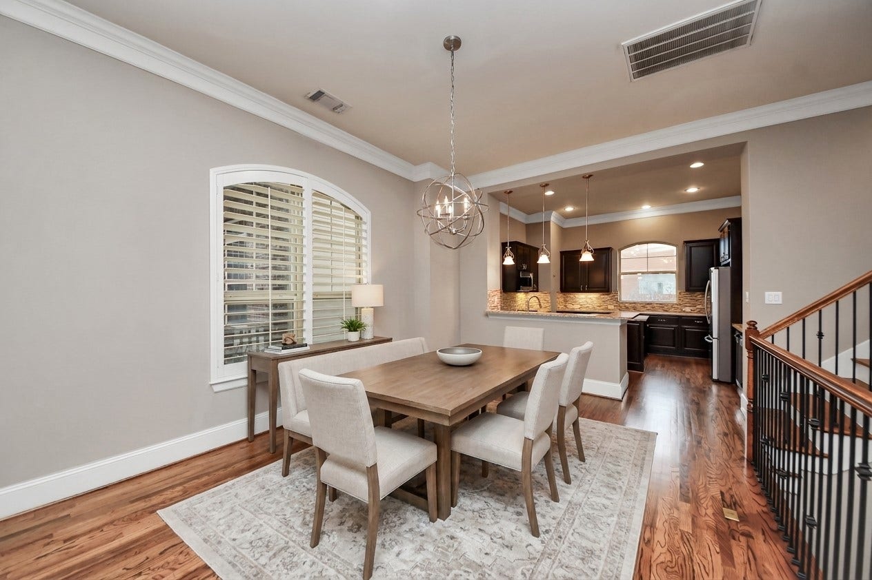 1617 W 23rd Street, Houston, TX 77008 Virtually Staged - Experience the perfect blend of elegance and functionality in this dining area, seamlessly flowing into a modern kitchen, ideal for both entertaining and everyday living.