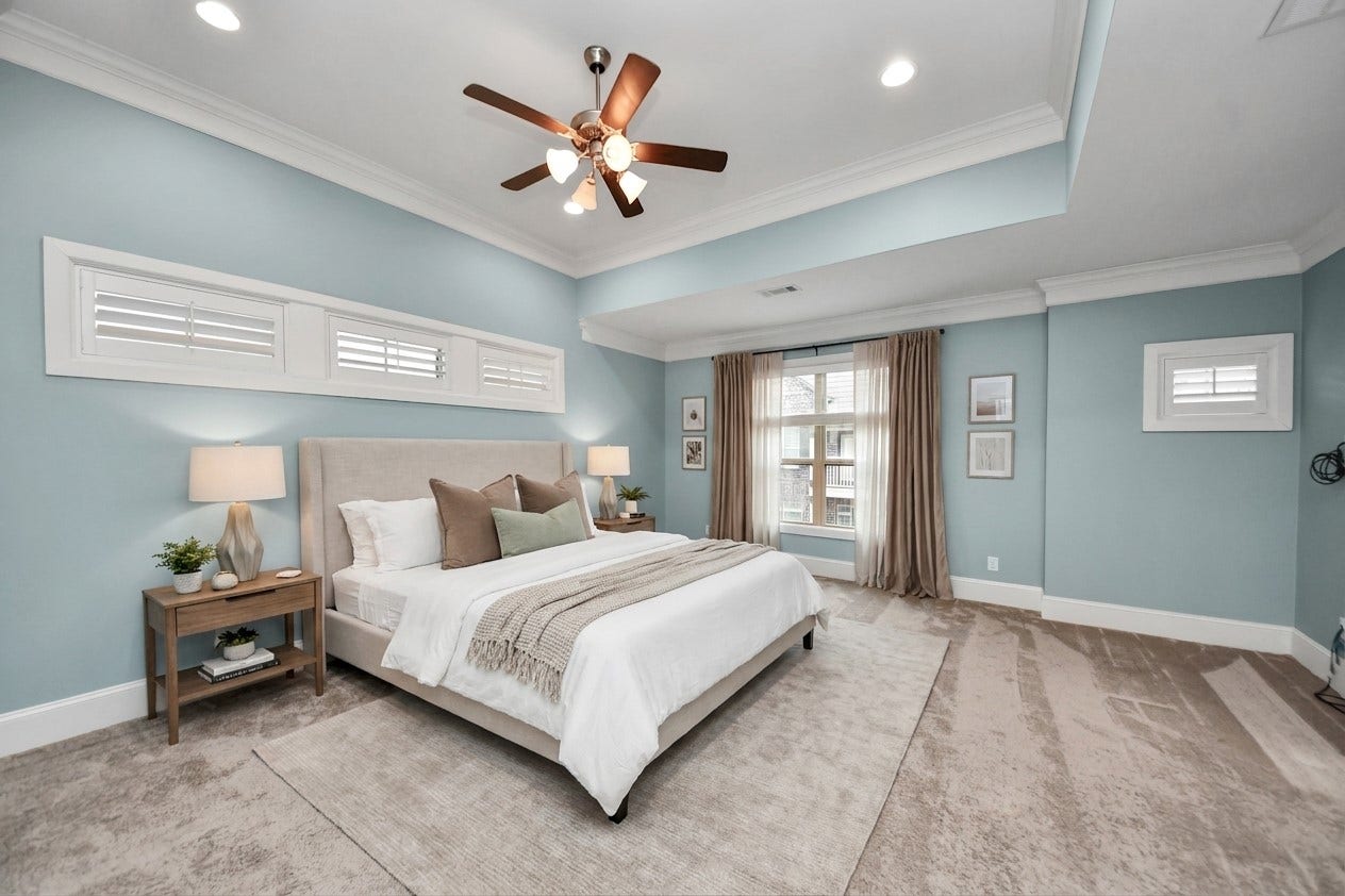 1617 W 23rd Street, Houston, TX 77008 Virtually Staged - Elegant primary bedroom offers a serene and spacious retreat with soft blue walls, abundant natural light, and stylish decor.