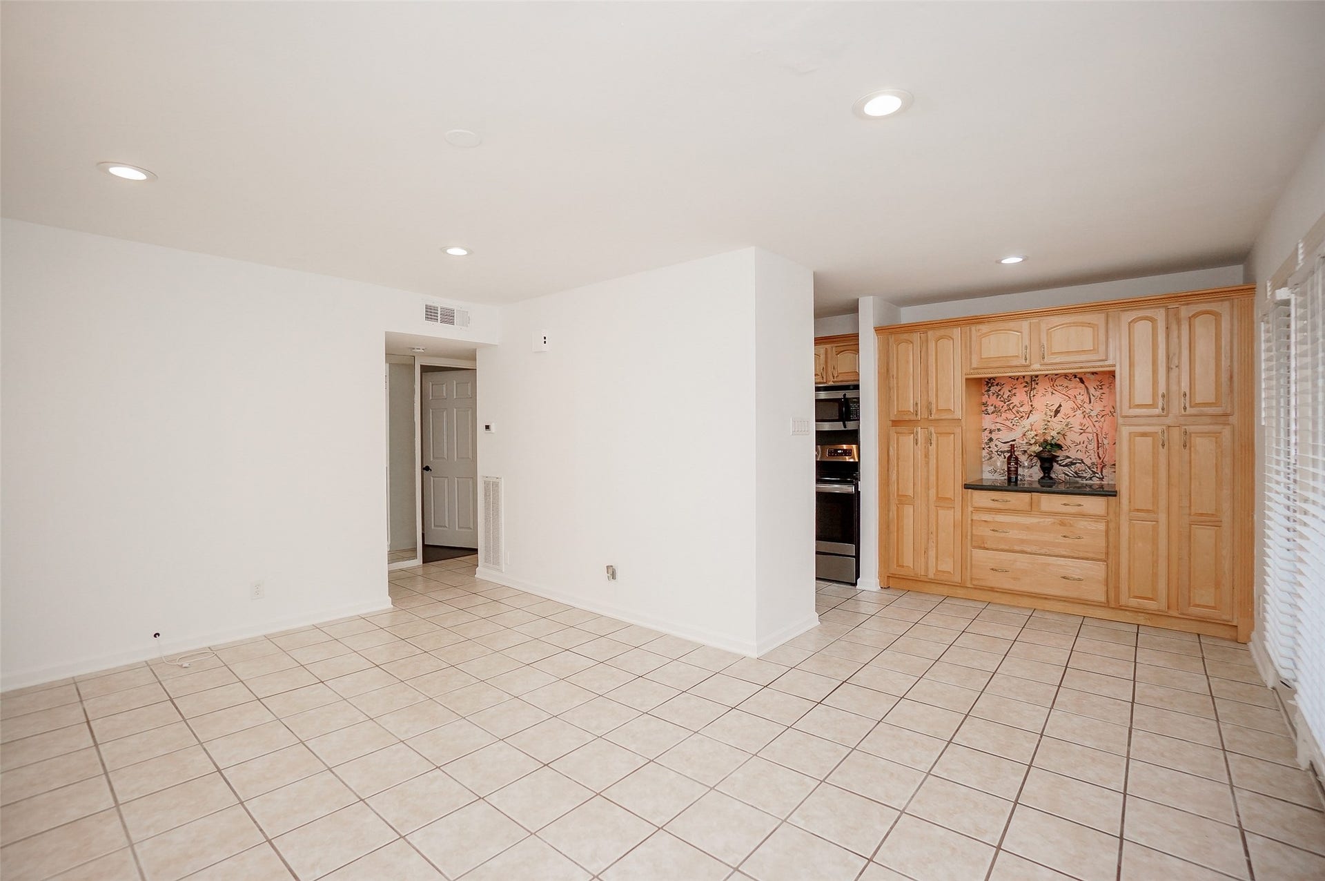 3942 W Alabama Street, #8, Houston, TX 77027 View of the family room/living area and dining and a glimpse of the kitchen and hallway to the bedroom.