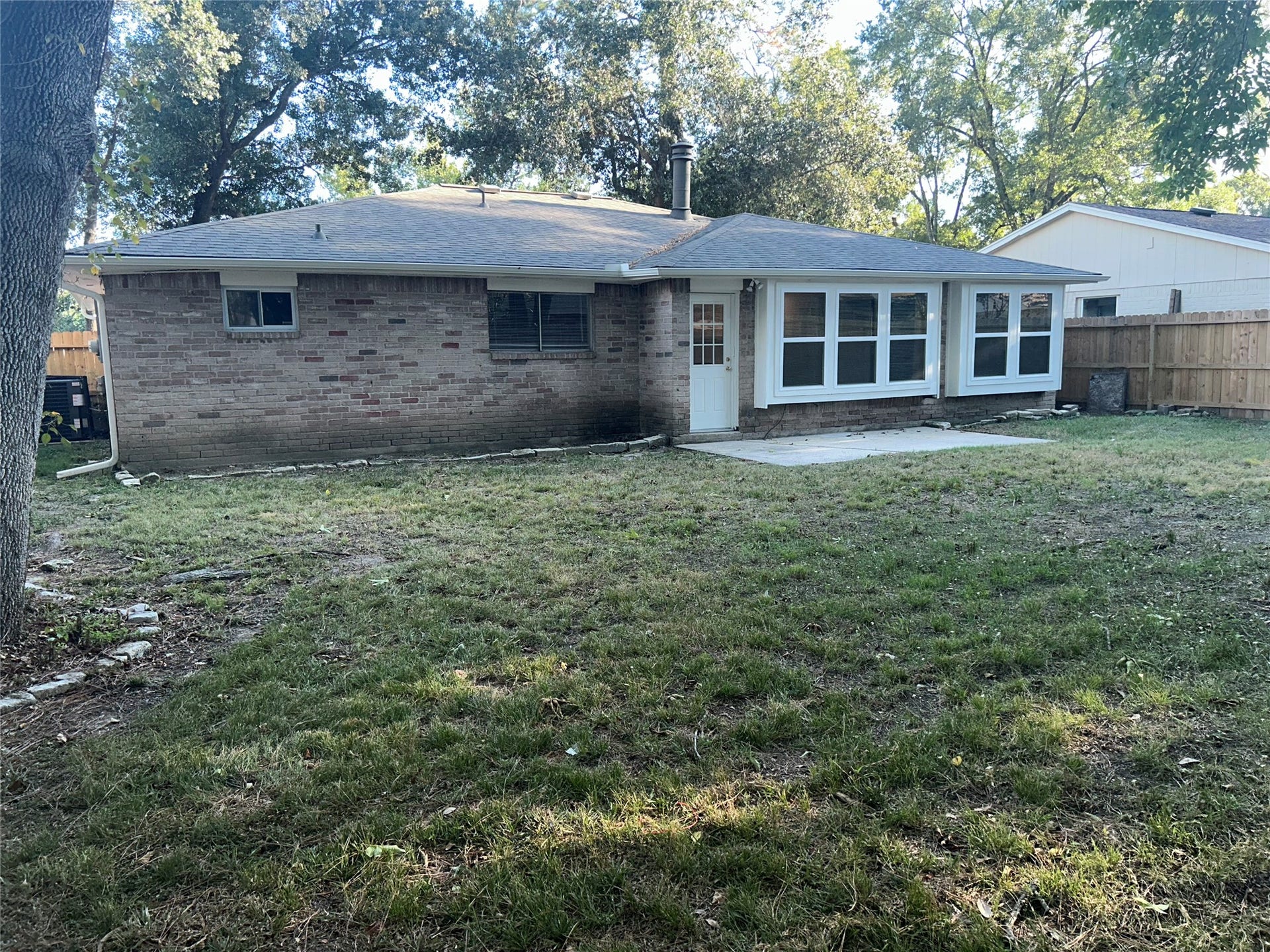 4251 Rosegate Drive, Spring, TX 77373 Large backyard with plenty of open lawn, mature shade trees, and a concrete patio just off the back door. Wood privacy fencing and a wall of windows across the back of the home round out the space.