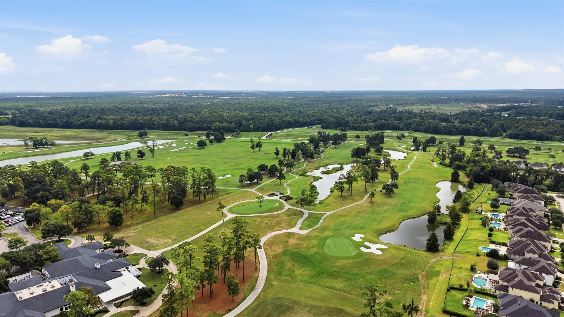 8311 Caroline Ridge Drive, Humble, TX 77396 Stunning aerial view of a lush golf course surrounded by serene water features and residential homes, offering a perfect blend of nature and luxury living.