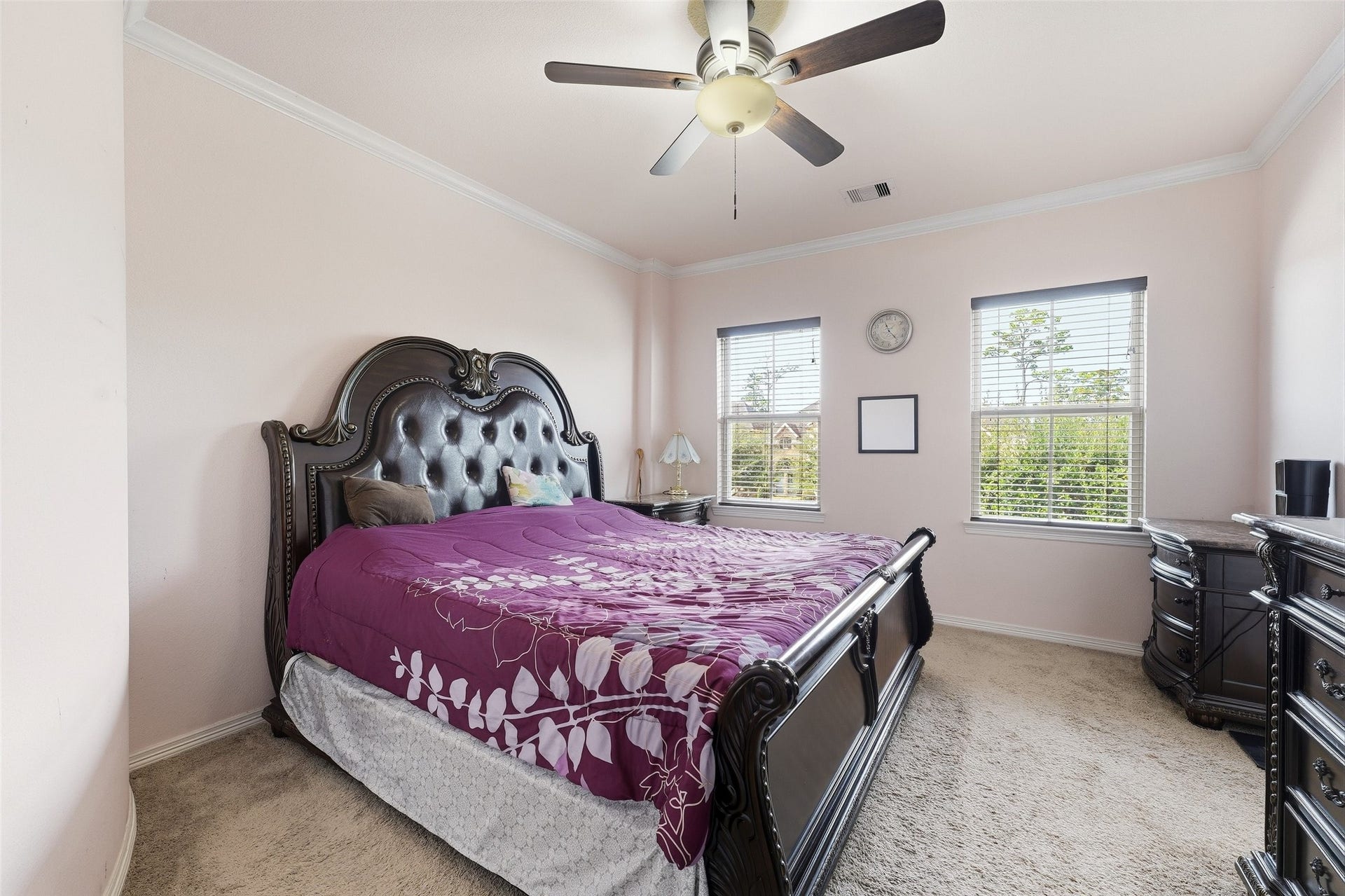 8311 Caroline Ridge Drive, Humble, TX 77396 Elegant bedroom complemented by two bright windows allowing natural light to fill the space.