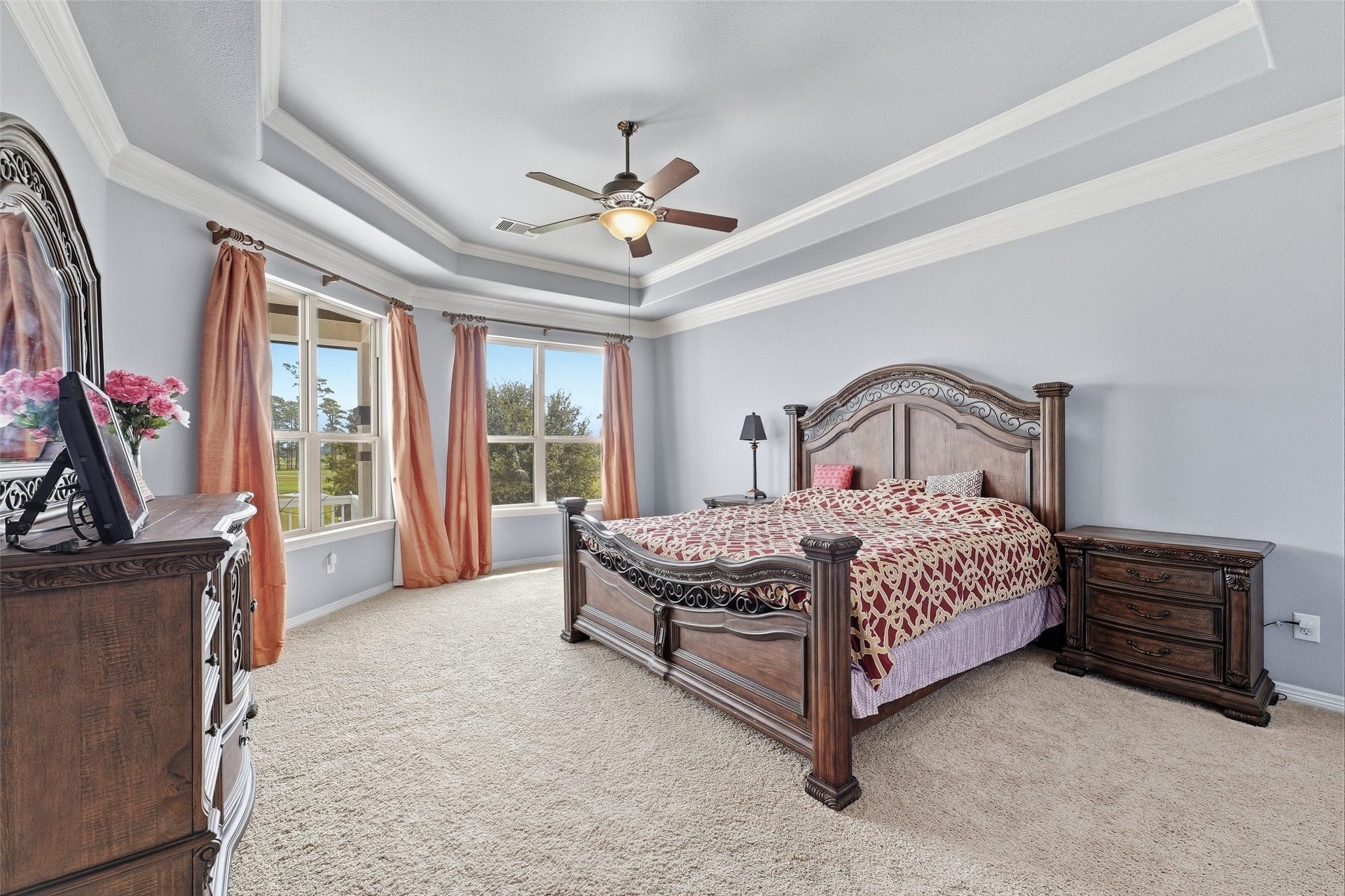 8311 Caroline Ridge Drive, Humble, TX 77396 Spacious game room featuring elegant tray ceilings, and abundant natural light from large windows transformed into a guest bedroom.