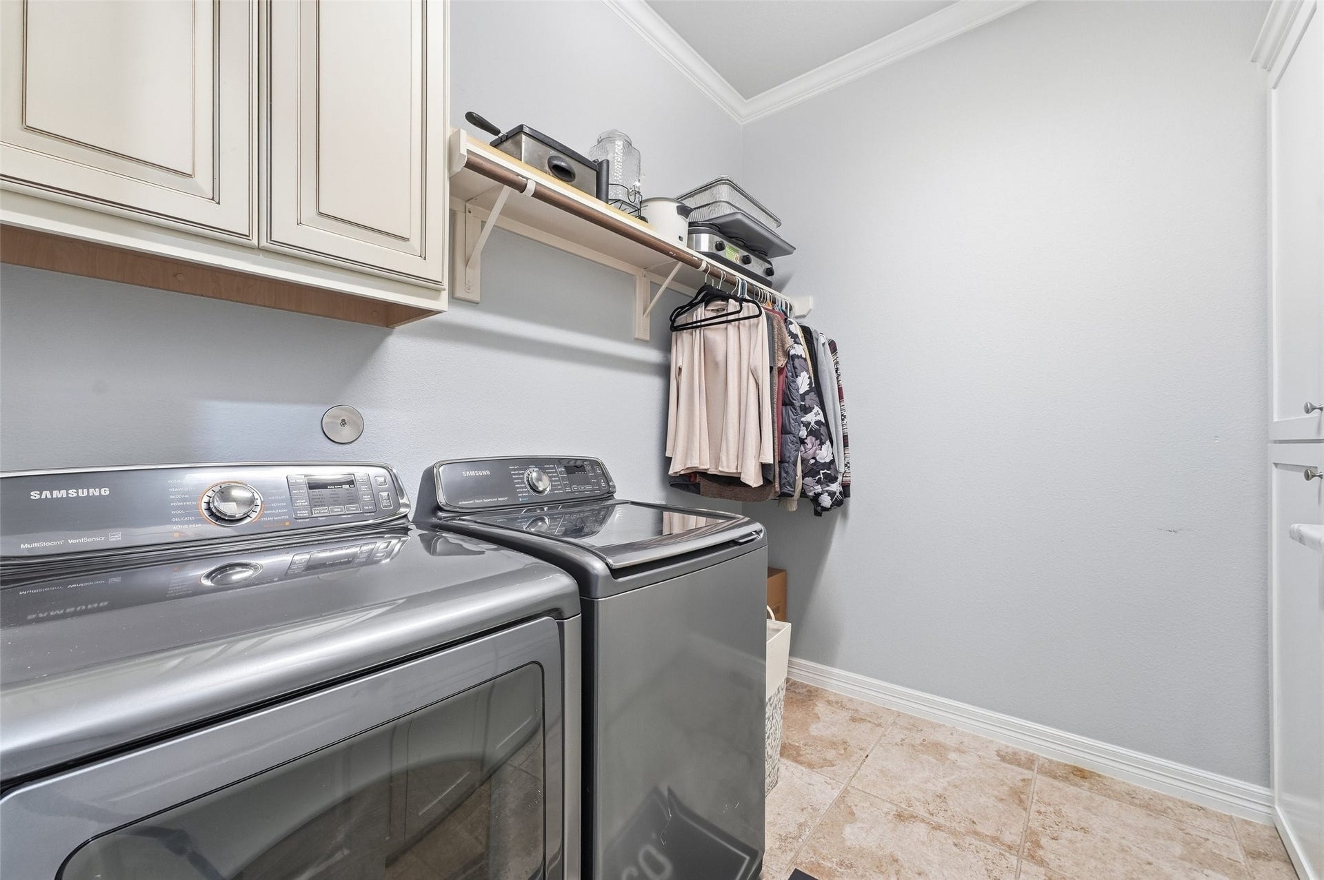 8311 Caroline Ridge Drive, Humble, TX 77396 Spacious laundry room featuring ample modern cabinetry, and shelving for storage and organization.