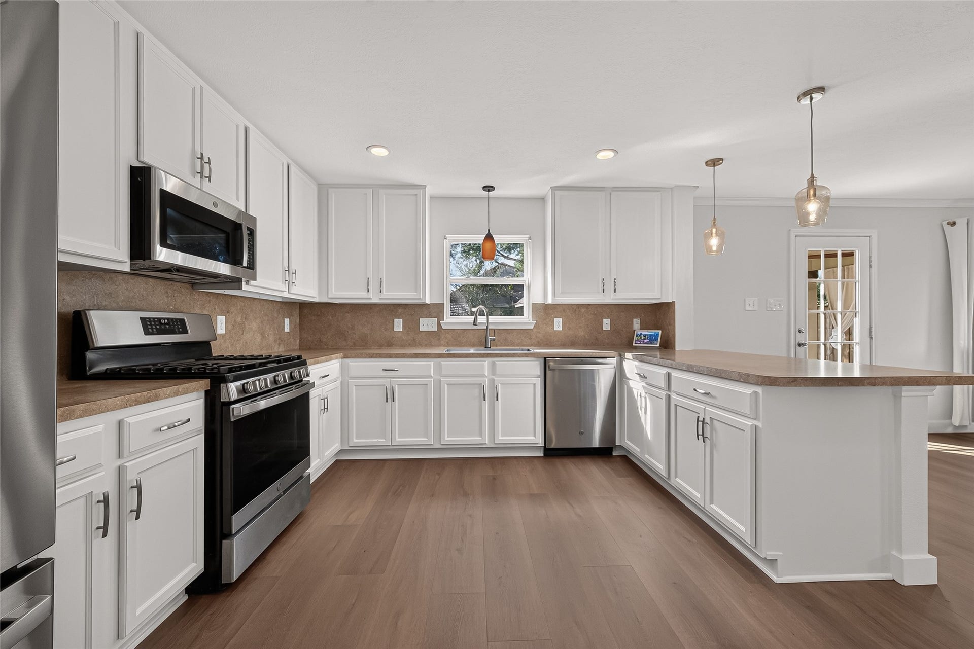 18019 Rexine Lane, Cypress, TX 77433 Spacious and modern kitchen with sleek white cabinetry, stainless steel appliances, perfect for entertaining.