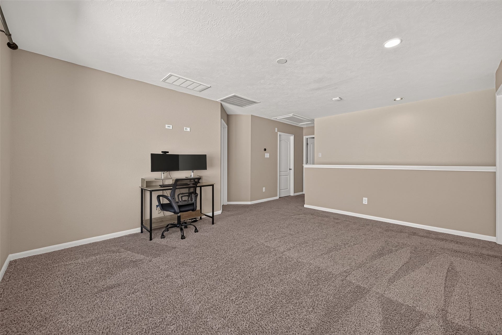 18019 Rexine Lane, Cypress, TX 77433 Spacious game room with plush carpeting, neutral walls, and recessed lighting, perfect for a home office or entertainment area.
