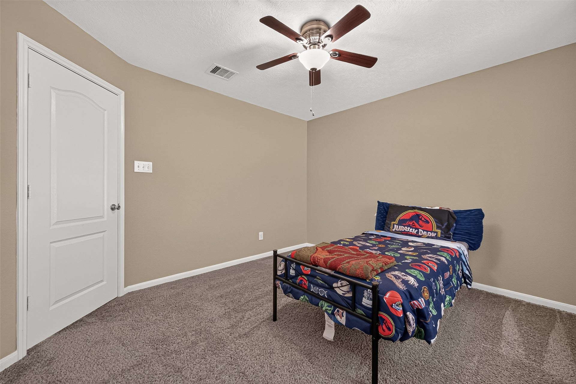 18019 Rexine Lane, Cypress, TX 77433 Cozy secondary bedroom with neutral walls, plush carpeting, and a ceiling fan, perfect for relaxation.