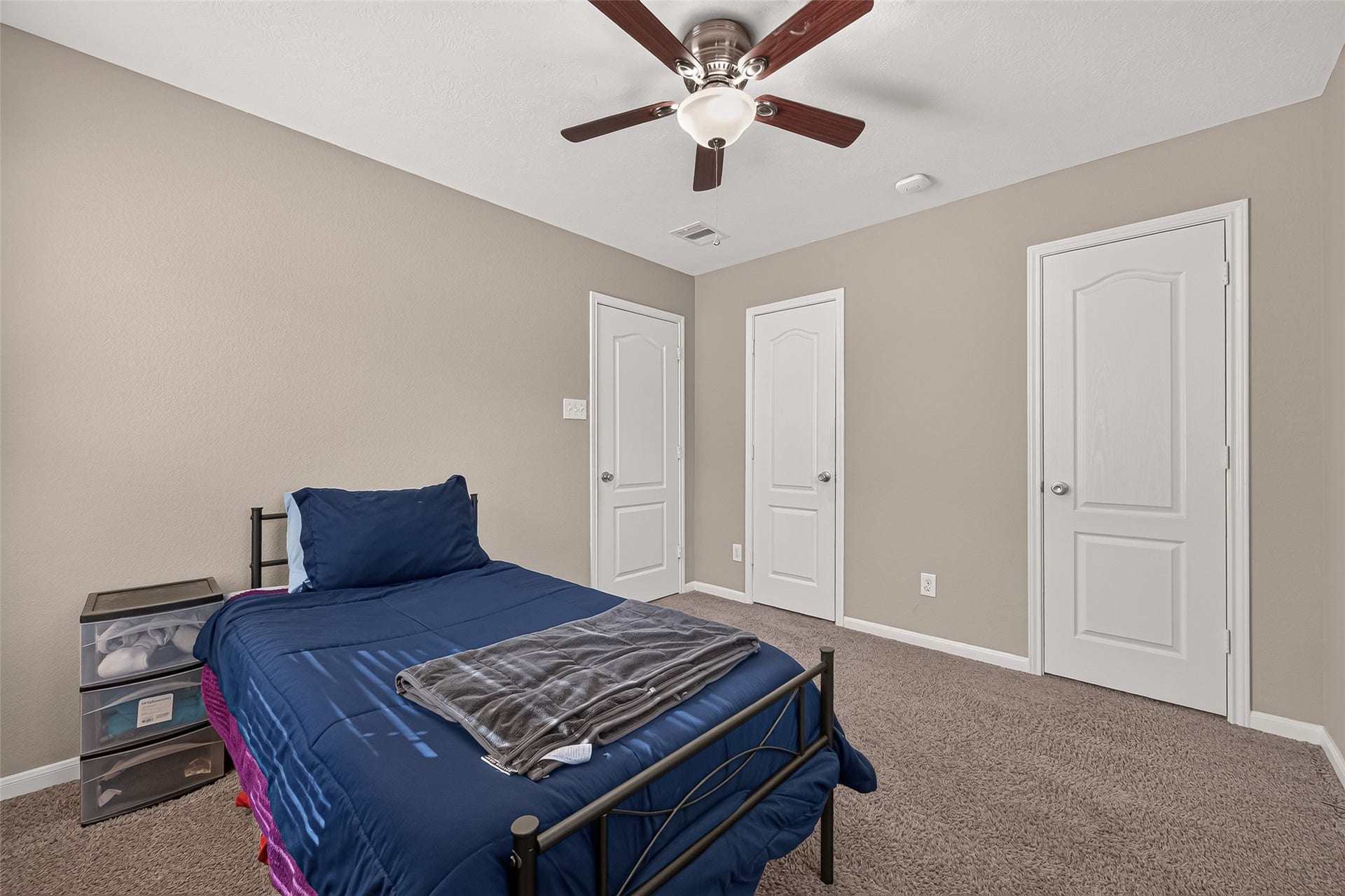 18019 Rexine Lane, Cypress, TX 77433 Cozy secondary bedroom with neutral walls, carpeted flooring, and a ceiling fan, featuring dual closets for ample storage.